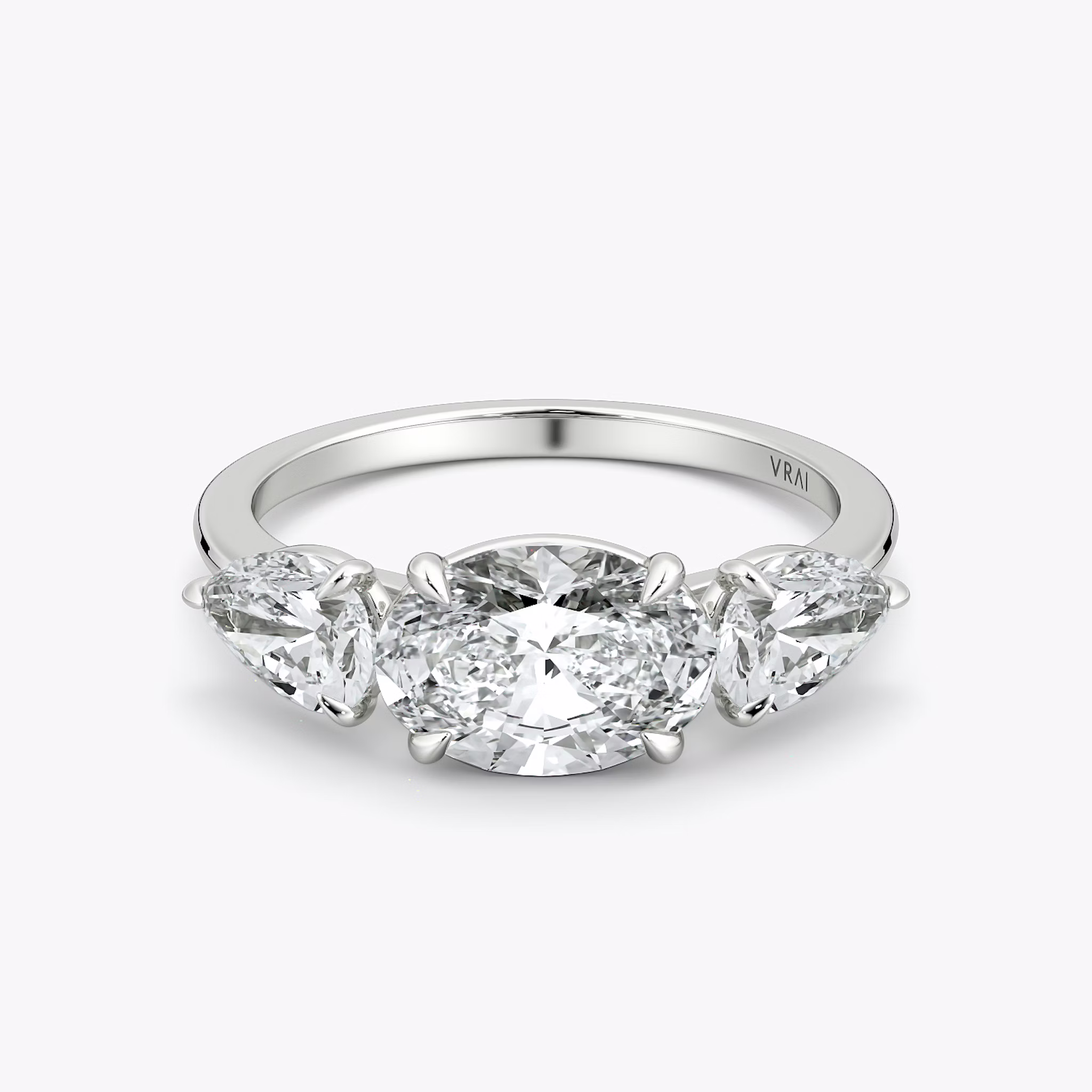The Three Stone | Oval | 18k | White Gold | bandAccent: Plain | diamondOrientation: horizontal | sideStoneCarat: 0.50ct | sideStoneShape: Pear | caratWeight: other