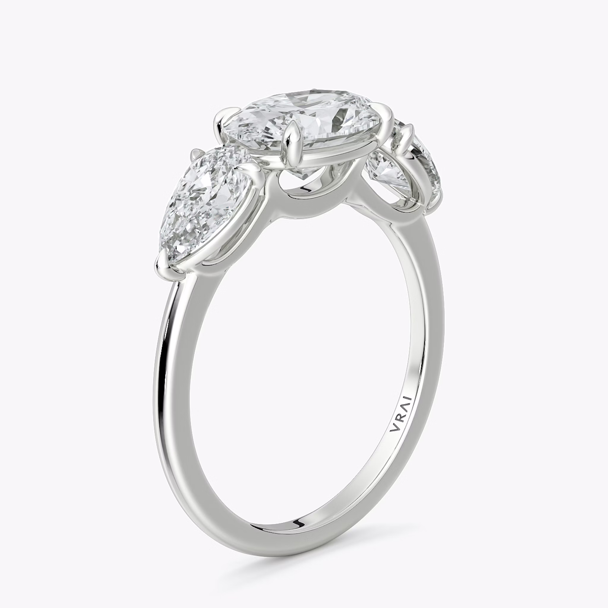 The Three Stone | Oval | 18k | White Gold | bandAccent: Plain | diamondOrientation: horizontal | sideStoneCarat: 0.50ct | sideStoneShape: Pear | caratWeight: other
