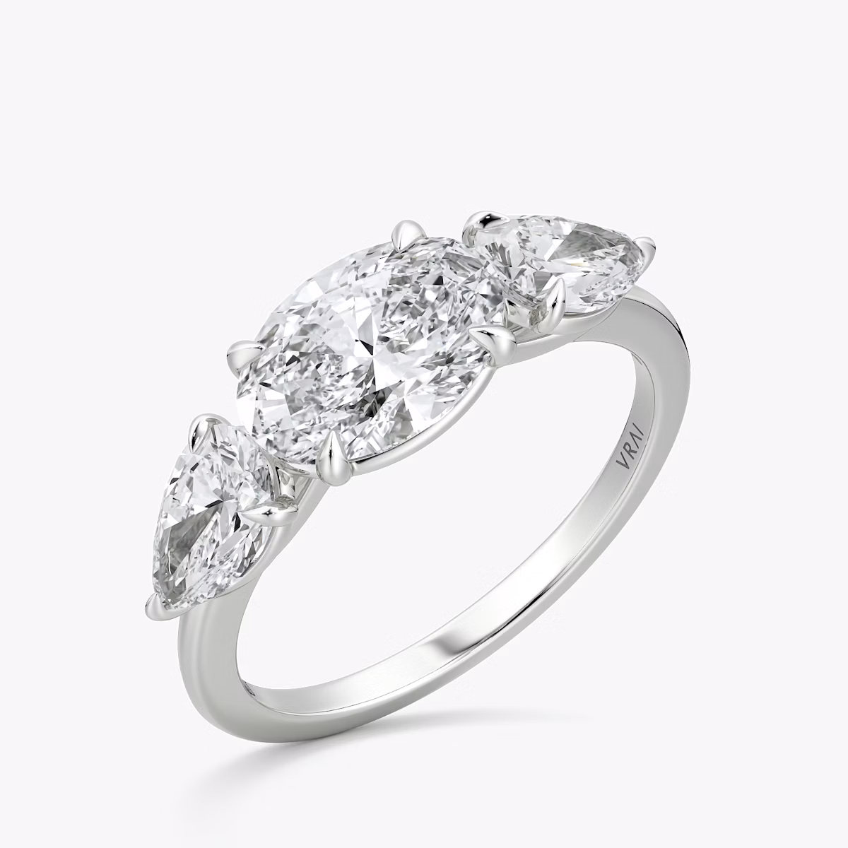 The Three Stone | Oval | 18k | White Gold | bandAccent: Plain | diamondOrientation: horizontal | sideStoneCarat: 0.50ct | sideStoneShape: Pear | caratWeight: other