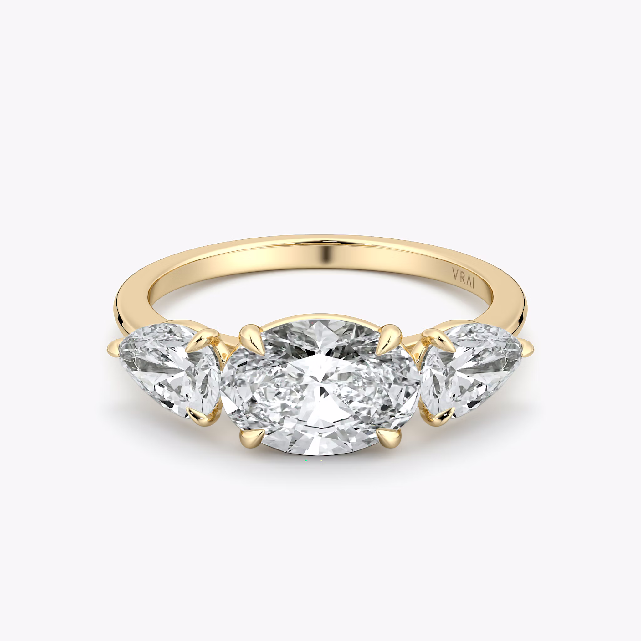 The Three Stone | Oval | 18k | Yellow Gold | bandAccent: Plain | diamondOrientation: horizontal | sideStoneCarat: 0.50ct | sideStoneShape: Pear | caratWeight: other