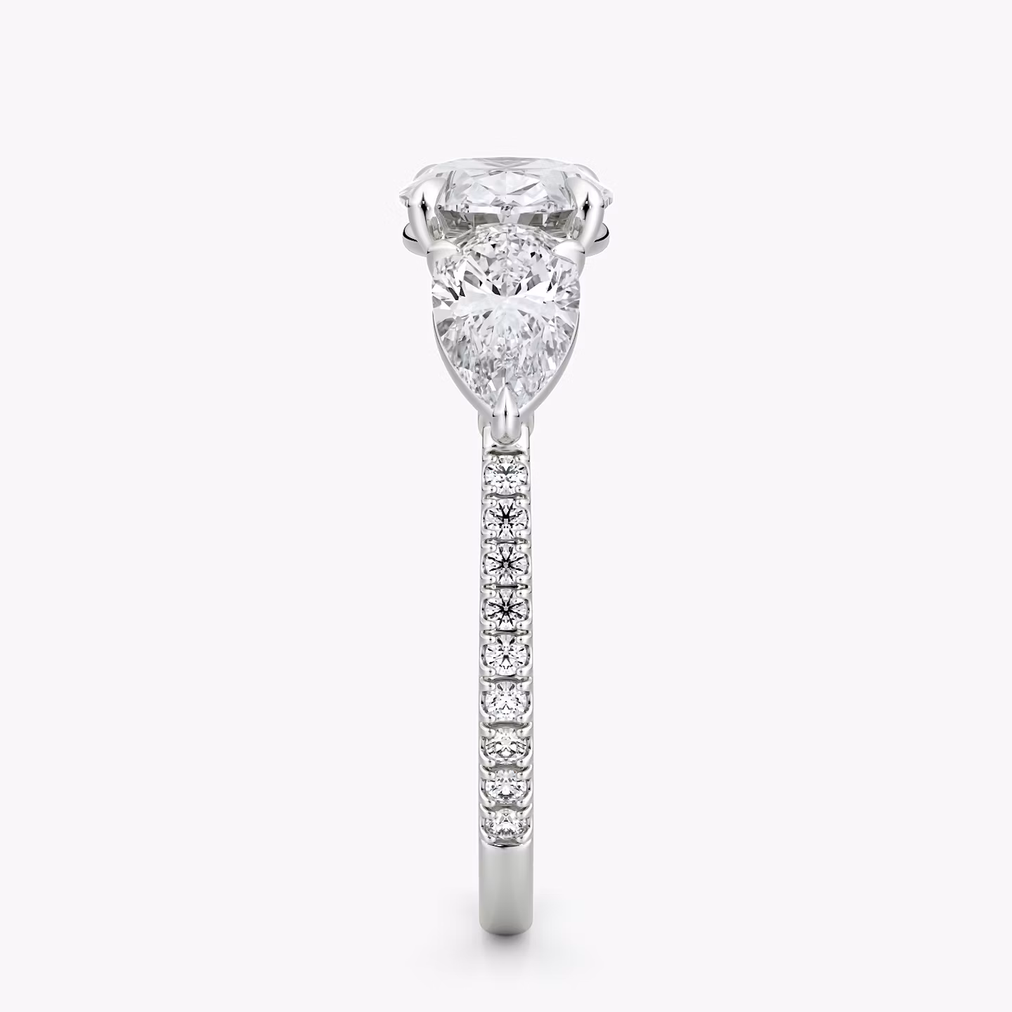 The Three Stone | Oval | Platinum | bandAccent: Pavé | diamondOrientation: horizontal | sideStoneCarat: 0.50ct | sideStoneShape: Pear | caratWeight: other