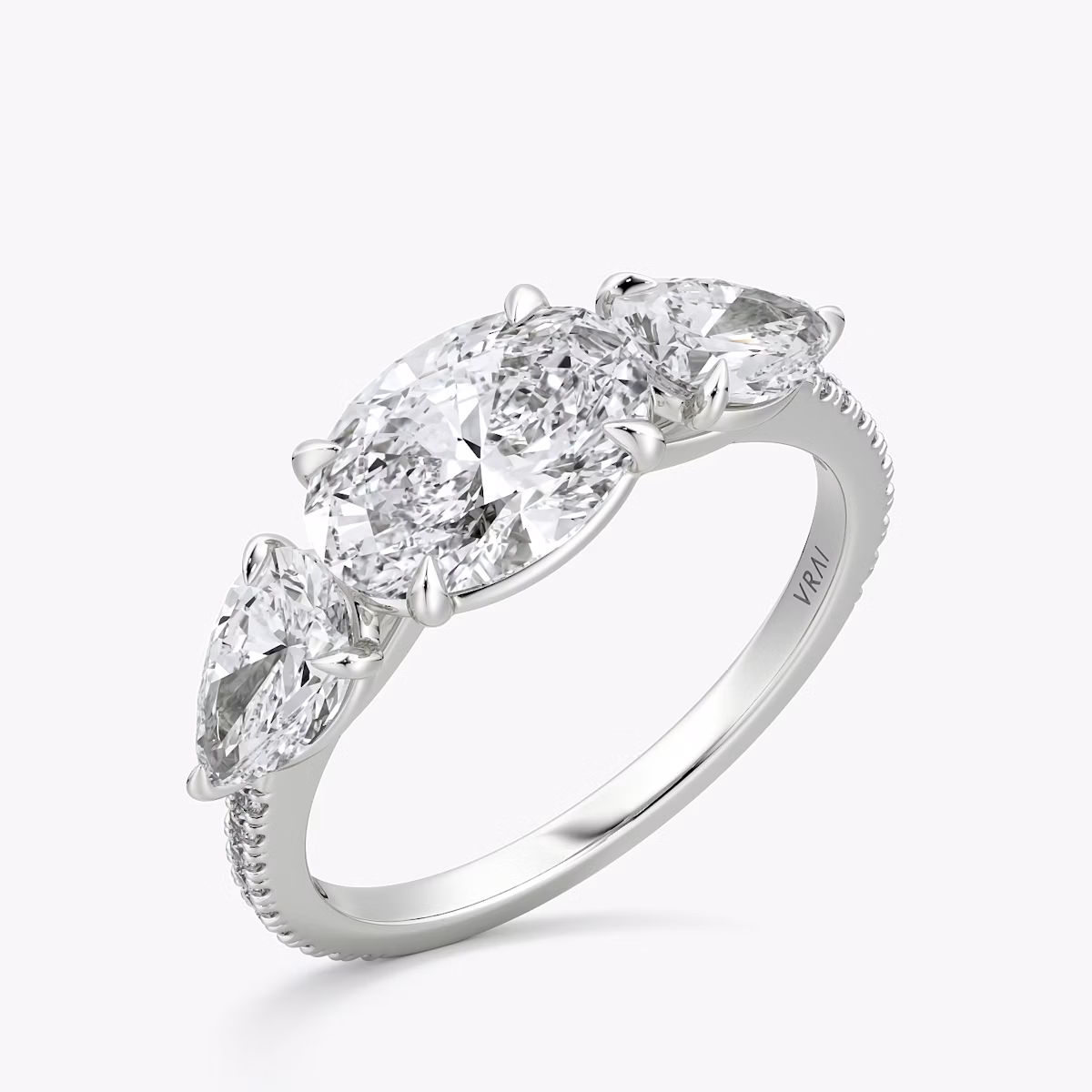 The Three Stone | Oval | 18k | White Gold | bandAccent: Pavé | diamondOrientation: horizontal | sideStoneCarat: 0.50ct | sideStoneShape: Pear | caratWeight: other