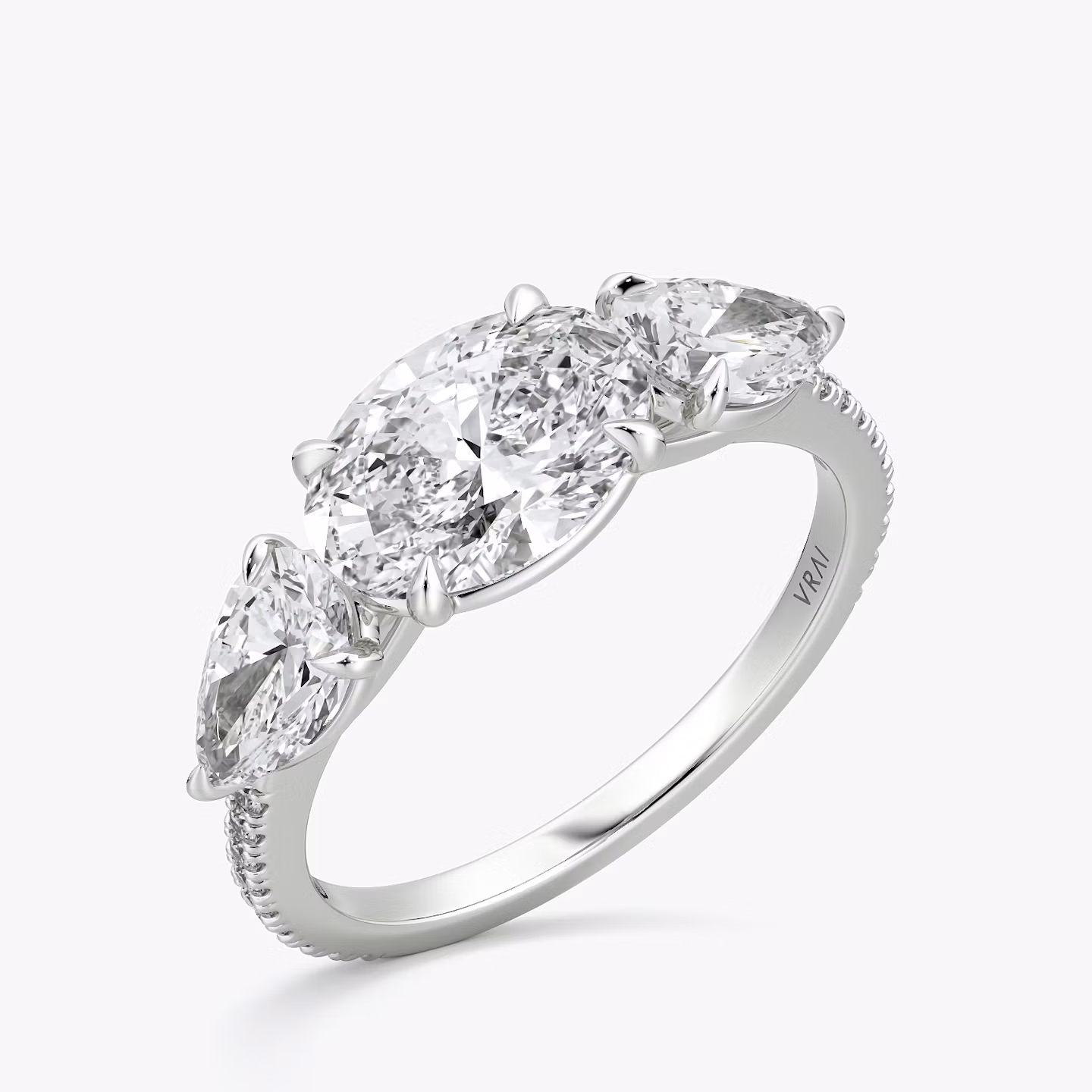 The Three Stone | Oval | Platinum | bandAccent: Pavé | diamondOrientation: horizontal | sideStoneCarat: 0.50ct | sideStoneShape: Pear | caratWeight: other