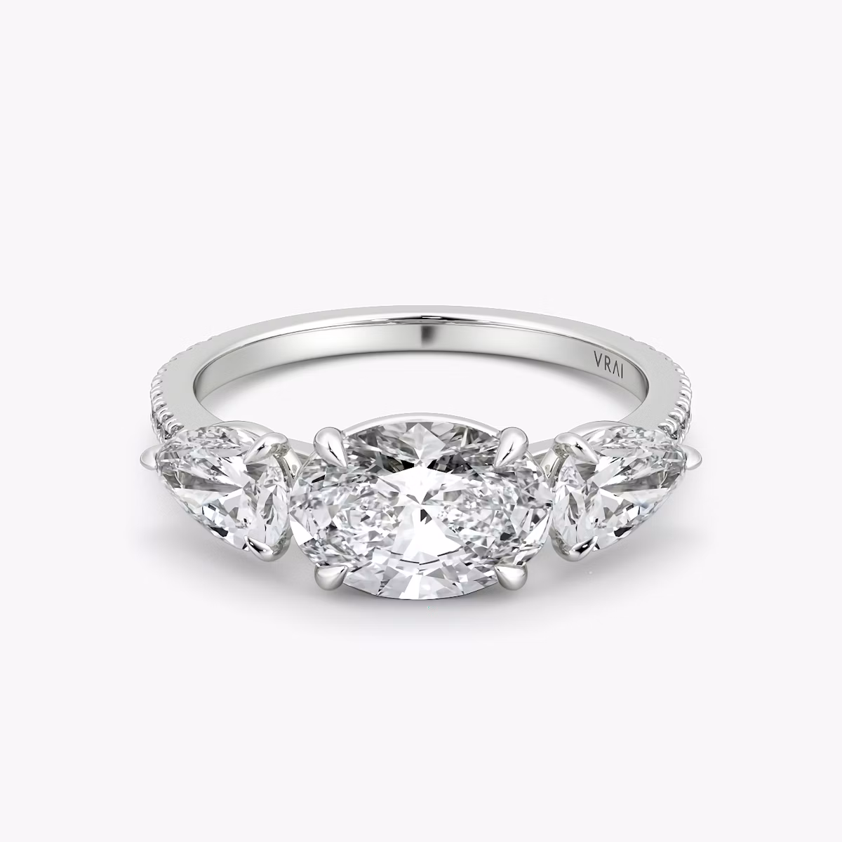 The Three Stone | Oval | 18k | White Gold | bandAccent: Pavé | diamondOrientation: horizontal | sideStoneCarat: 0.50ct | sideStoneShape: Pear | caratWeight: other