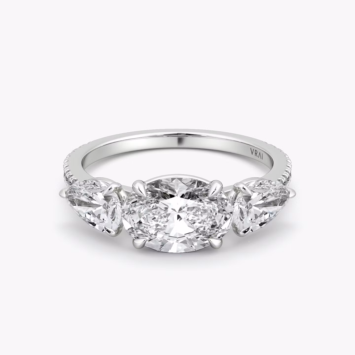 The Three Stone | Oval | Platinum | bandAccent: Pavé | diamondOrientation: horizontal | sideStoneCarat: 0.50ct | sideStoneShape: Pear | caratWeight: other