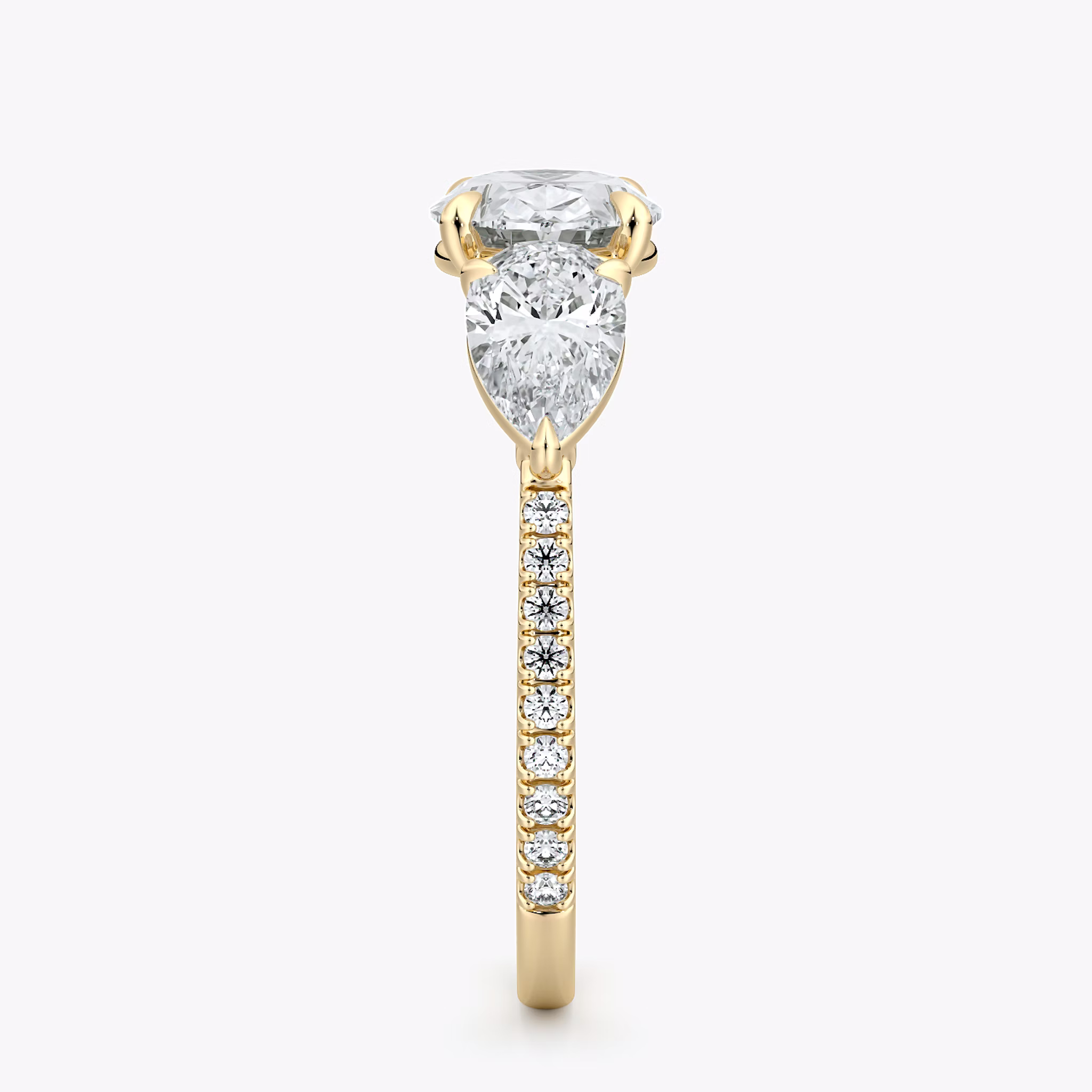 The Three Stone | Oval | 18k | Yellow Gold | bandAccent: Pavé | diamondOrientation: horizontal | sideStoneCarat: 0.50ct | sideStoneShape: Pear | caratWeight: other