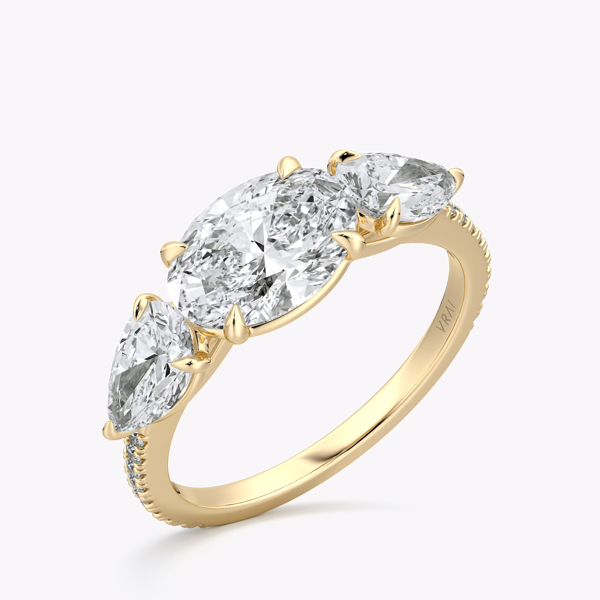 The Three Stone | Oval | 18k | Yellow Gold | bandAccent: Pavé | diamondOrientation: horizontal | sideStoneCarat: 0.50ct | sideStoneShape: Pear | caratWeight: other