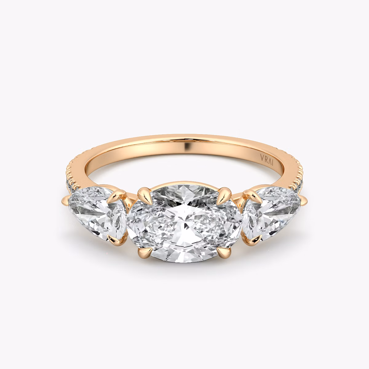 The Three Stone | Oval | 14k | Rose Gold | bandAccent: Pavé | diamondOrientation: horizontal | sideStoneCarat: 0.50ct | sideStoneShape: Pear | caratWeight: other