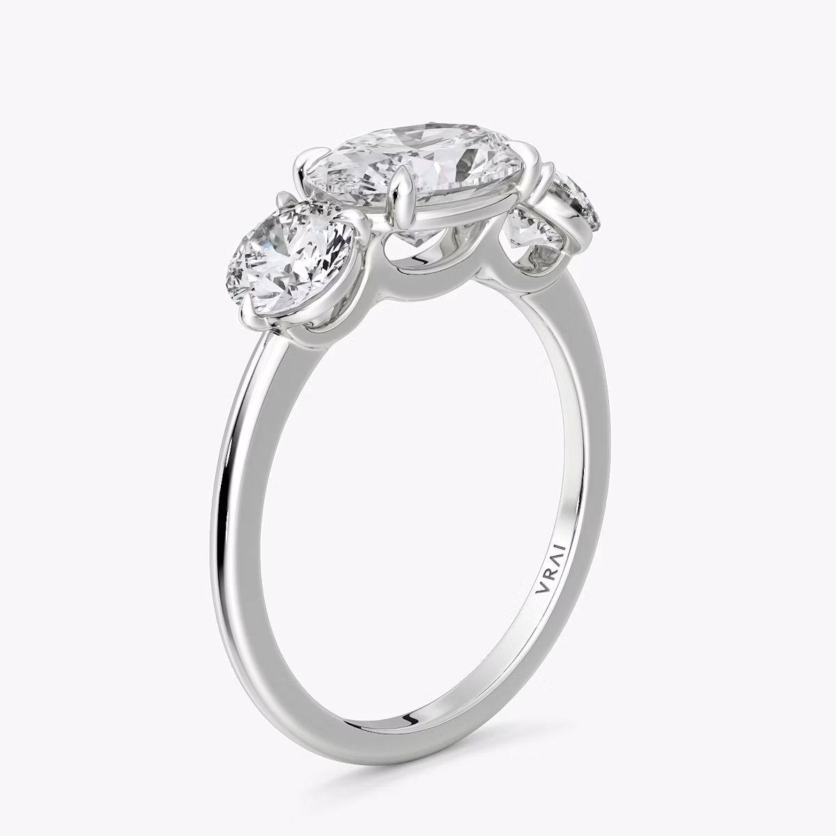 The Three Stone | Oval | 18k | White Gold | bandAccent: Plain | diamondOrientation: horizontal | sideStoneCarat: 0.50ct | sideStoneShape: Round Brilliant | caratWeight: other