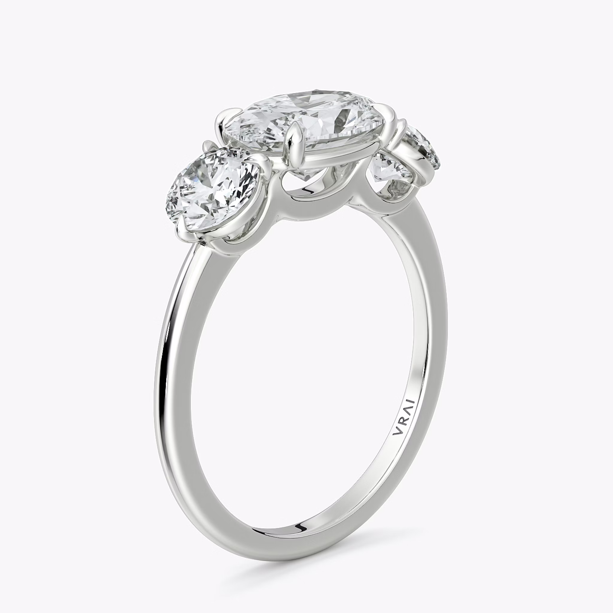 The Three Stone | Oval | 18k | White Gold | bandAccent: Plain | diamondOrientation: horizontal | sideStoneCarat: 0.50ct | sideStoneShape: Round Brilliant | caratWeight: other