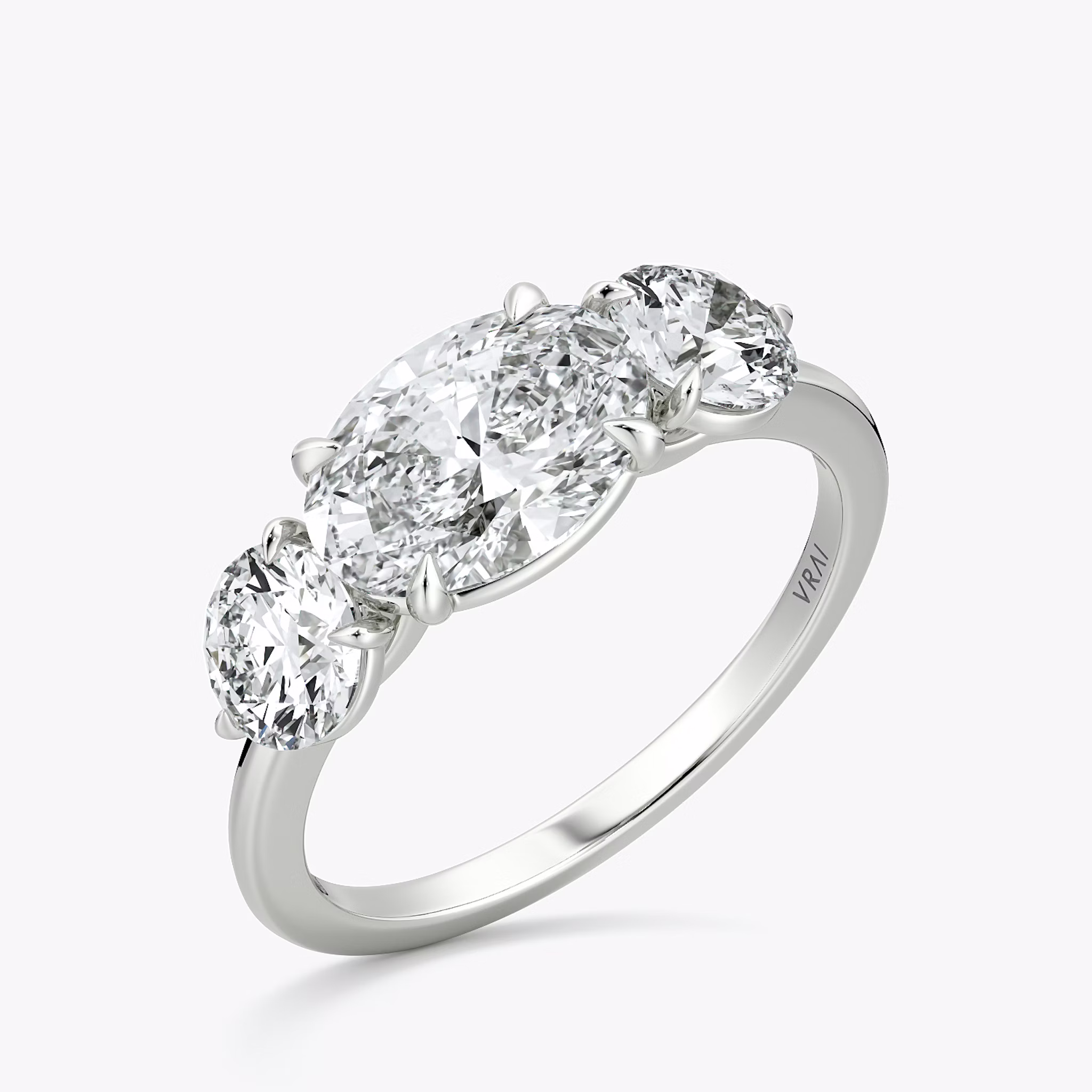 The Three Stone | Oval | 18k | White Gold | bandAccent: Plain | diamondOrientation: horizontal | sideStoneCarat: 0.50ct | sideStoneShape: Round Brilliant | caratWeight: other