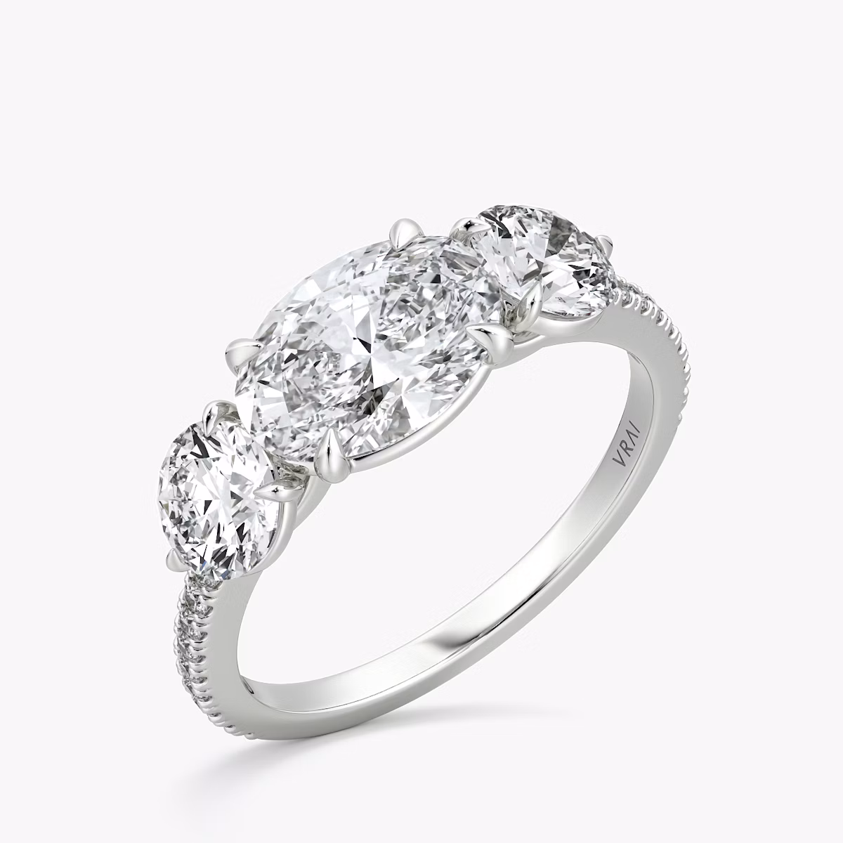 The Three Stone | Oval | 18k | White Gold | bandAccent: Pavé | diamondOrientation: horizontal | sideStoneCarat: 0.50ct | sideStoneShape: Round Brilliant | caratWeight: other