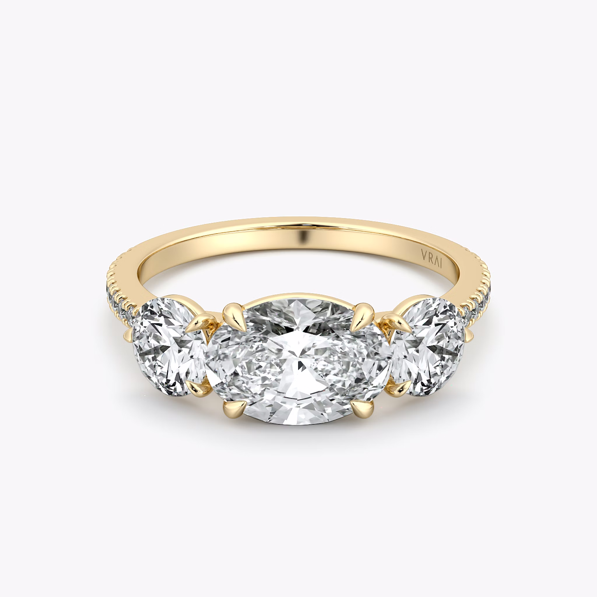 The Three Stone | Oval | 18k | Yellow Gold | bandAccent: Pavé | diamondOrientation: horizontal | sideStoneCarat: 0.50ct | sideStoneShape: Round Brilliant | caratWeight: other
