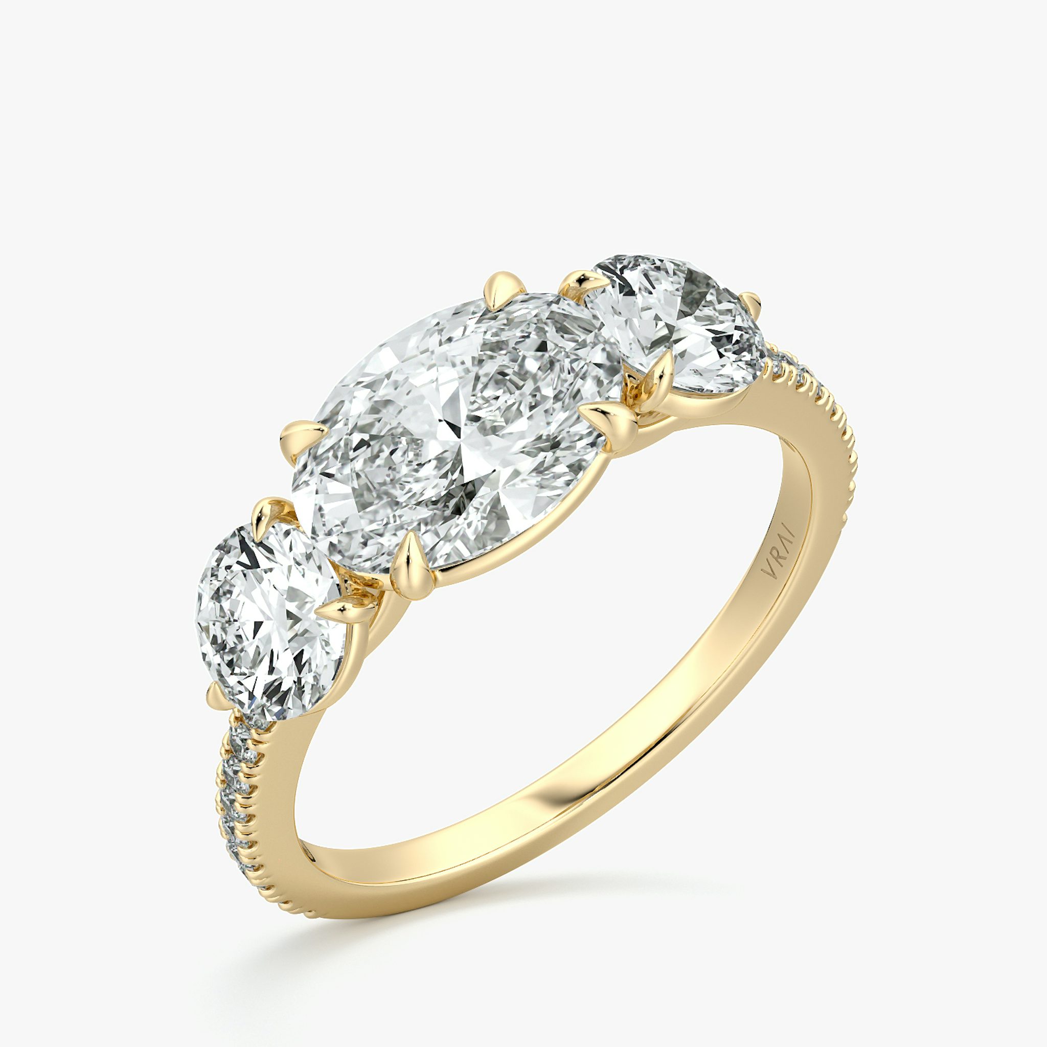The Three Stone | Oval | 18k | Yellow Gold | bandAccent: Pavé | diamondOrientation: horizontal | sideStoneCarat: 0.50ct | sideStoneShape: Round Brilliant | caratWeight: other