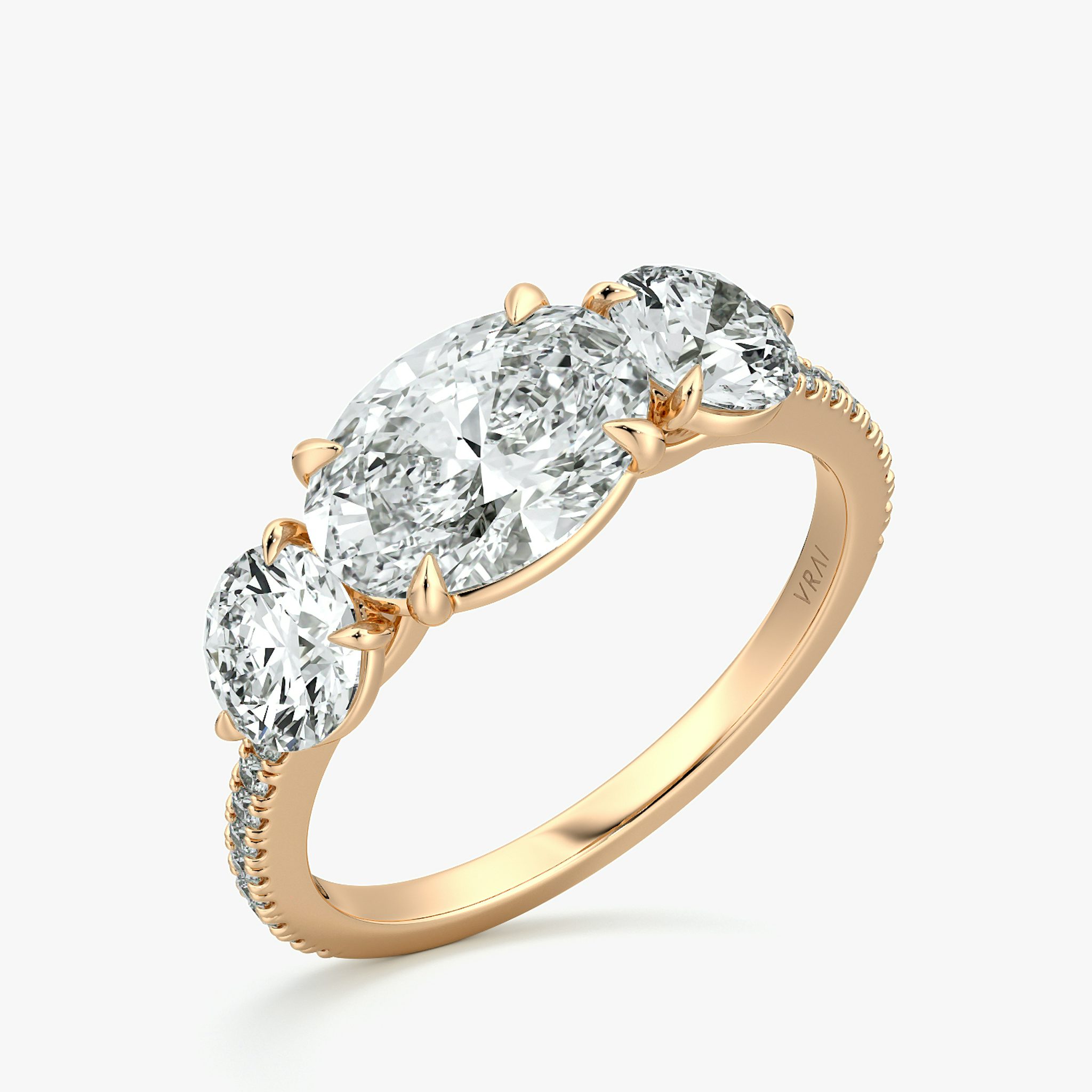 The Three Stone | Oval | 14k | Rose Gold | bandAccent: Pavé | diamondOrientation: horizontal | sideStoneCarat: 0.50ct | sideStoneShape: Round Brilliant | caratWeight: other