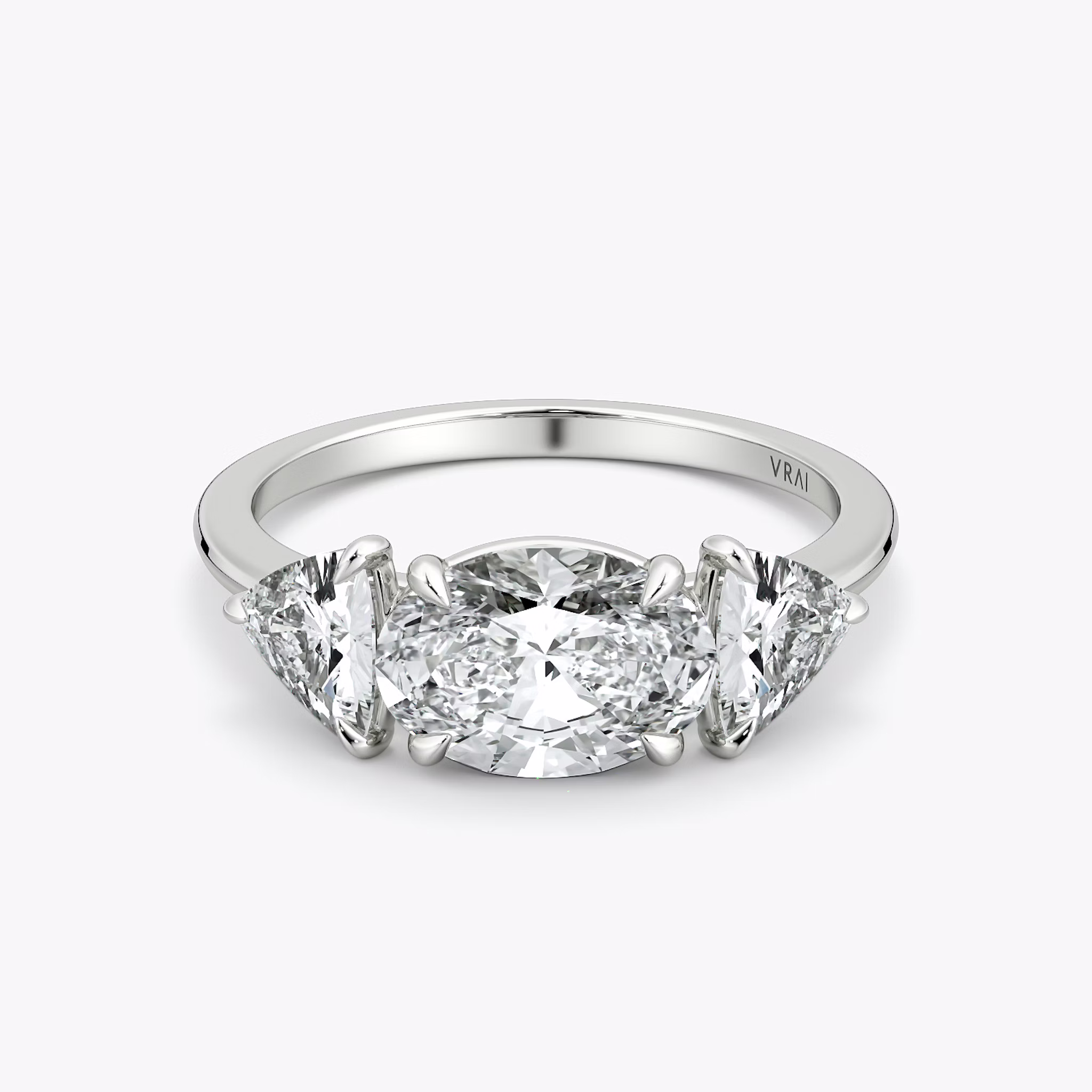 The Three Stone | Oval | 18k | White Gold | bandAccent: Plain | diamondOrientation: horizontal | sideStoneCarat: 0.50ct | sideStoneShape: Trillion | caratWeight: other