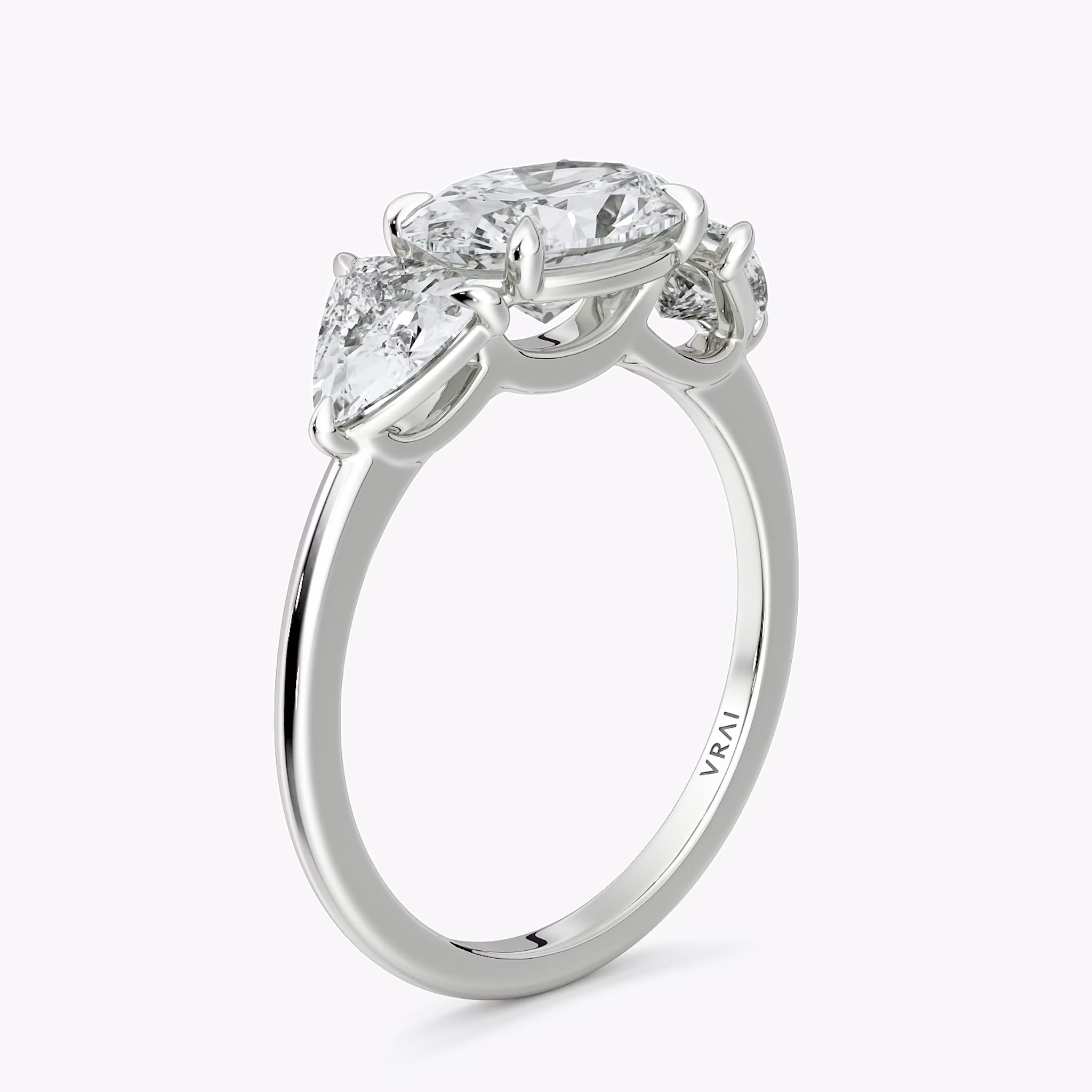 The Three Stone | Oval | 18k | White Gold | bandAccent: Plain | diamondOrientation: horizontal | sideStoneCarat: 0.50ct | sideStoneShape: Trillion | caratWeight: other