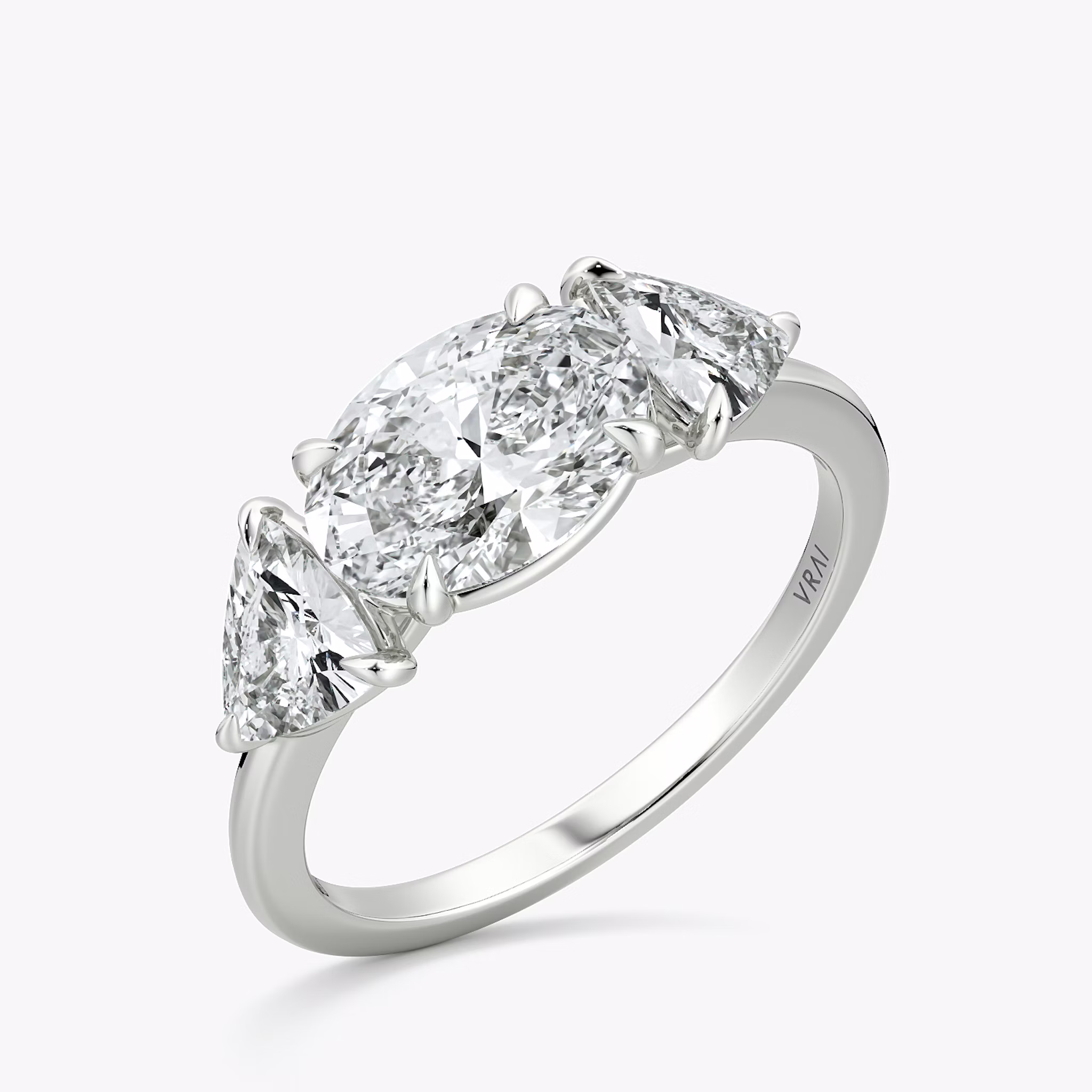 The Three Stone | Oval | 18k | White Gold | bandAccent: Plain | diamondOrientation: horizontal | sideStoneCarat: 0.50ct | sideStoneShape: Trillion | caratWeight: other