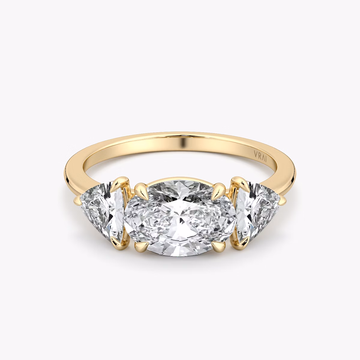 The Three Stone | Oval | 18k | Yellow Gold | bandAccent: Plain | diamondOrientation: horizontal | sideStoneCarat: 0.50ct | sideStoneShape: Trillion | caratWeight: other