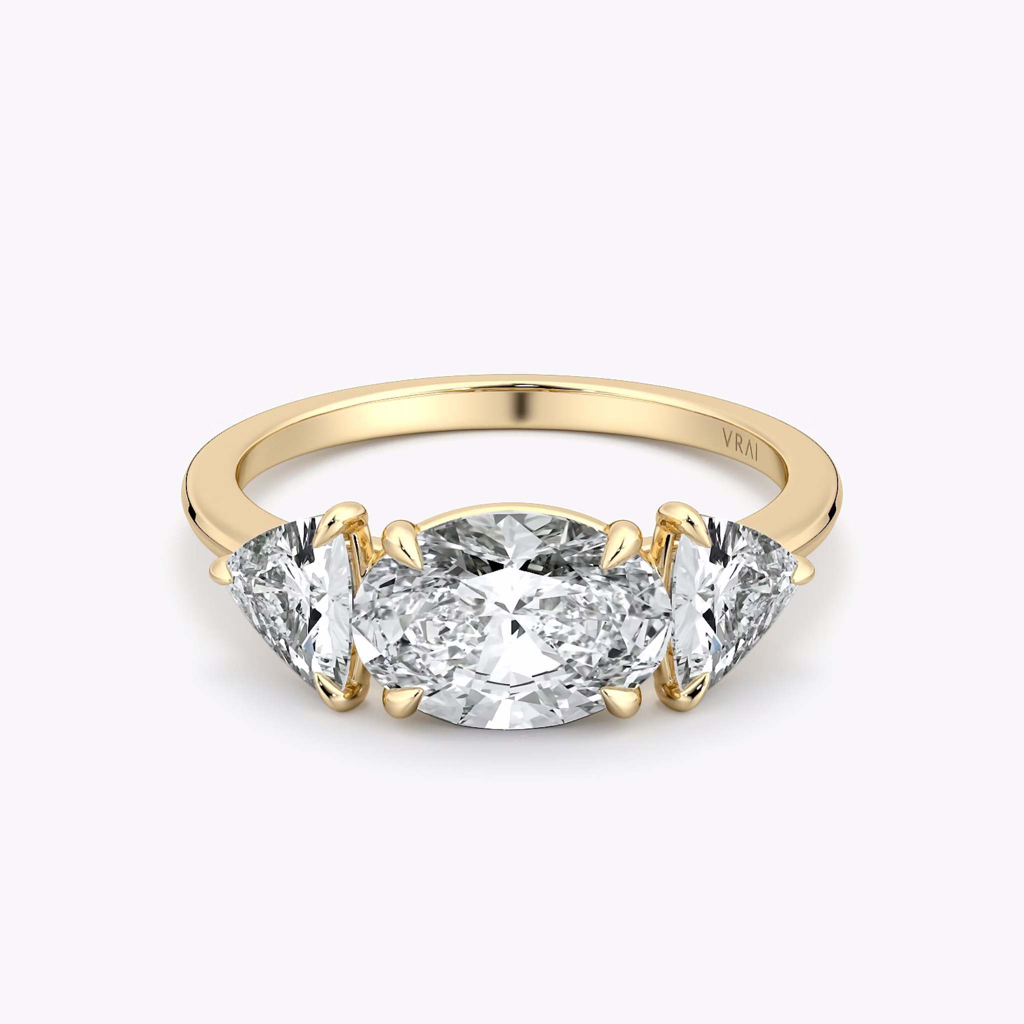 The Three Stone | Oval | 18k | Yellow Gold | bandAccent: Plain | diamondOrientation: horizontal | sideStoneCarat: 0.50ct | sideStoneShape: Trillion | caratWeight: other