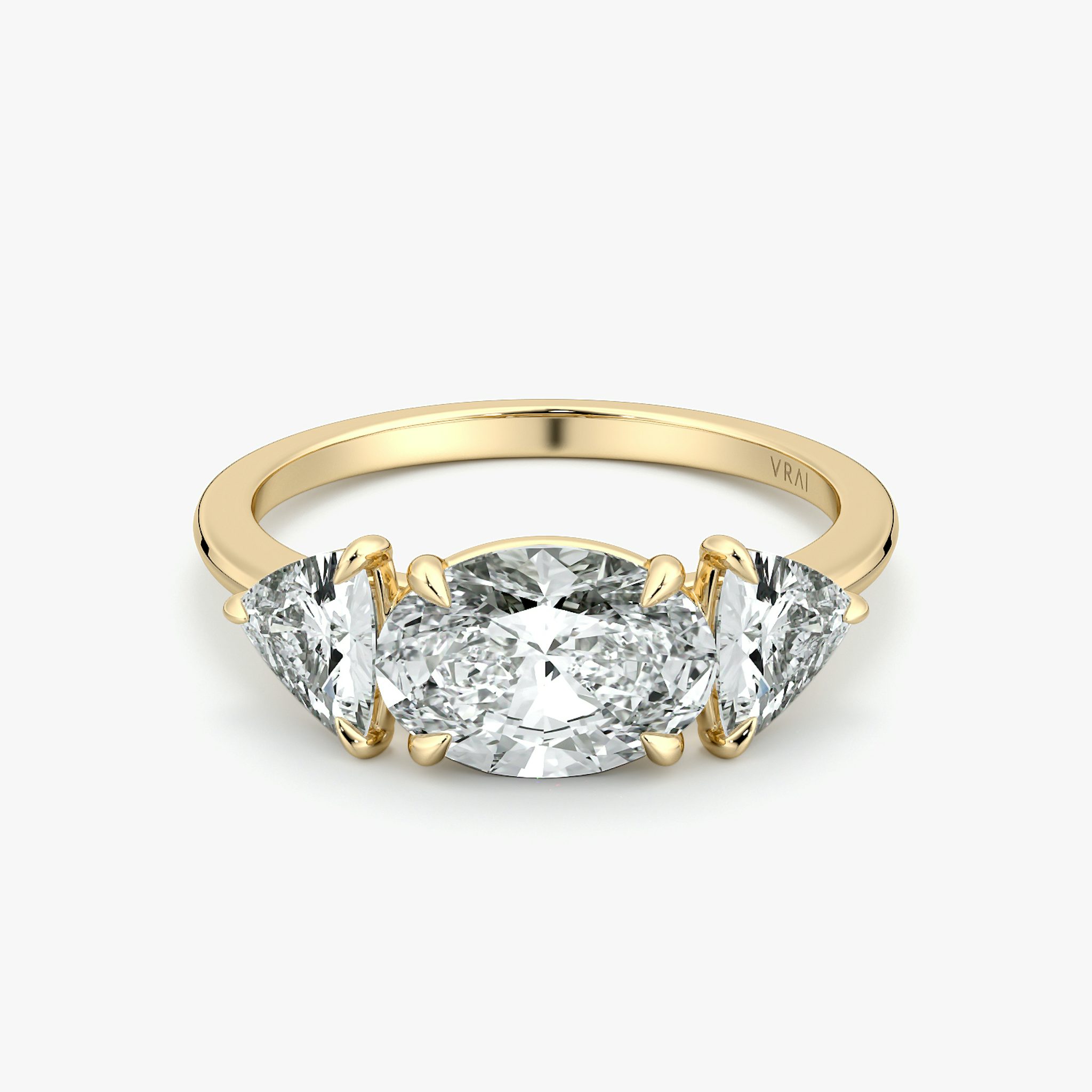 The Three Stone | Oval | 18k | Yellow Gold | bandAccent: Plain | diamondOrientation: horizontal | sideStoneCarat: 0.50ct | sideStoneShape: Trillion | caratWeight: other