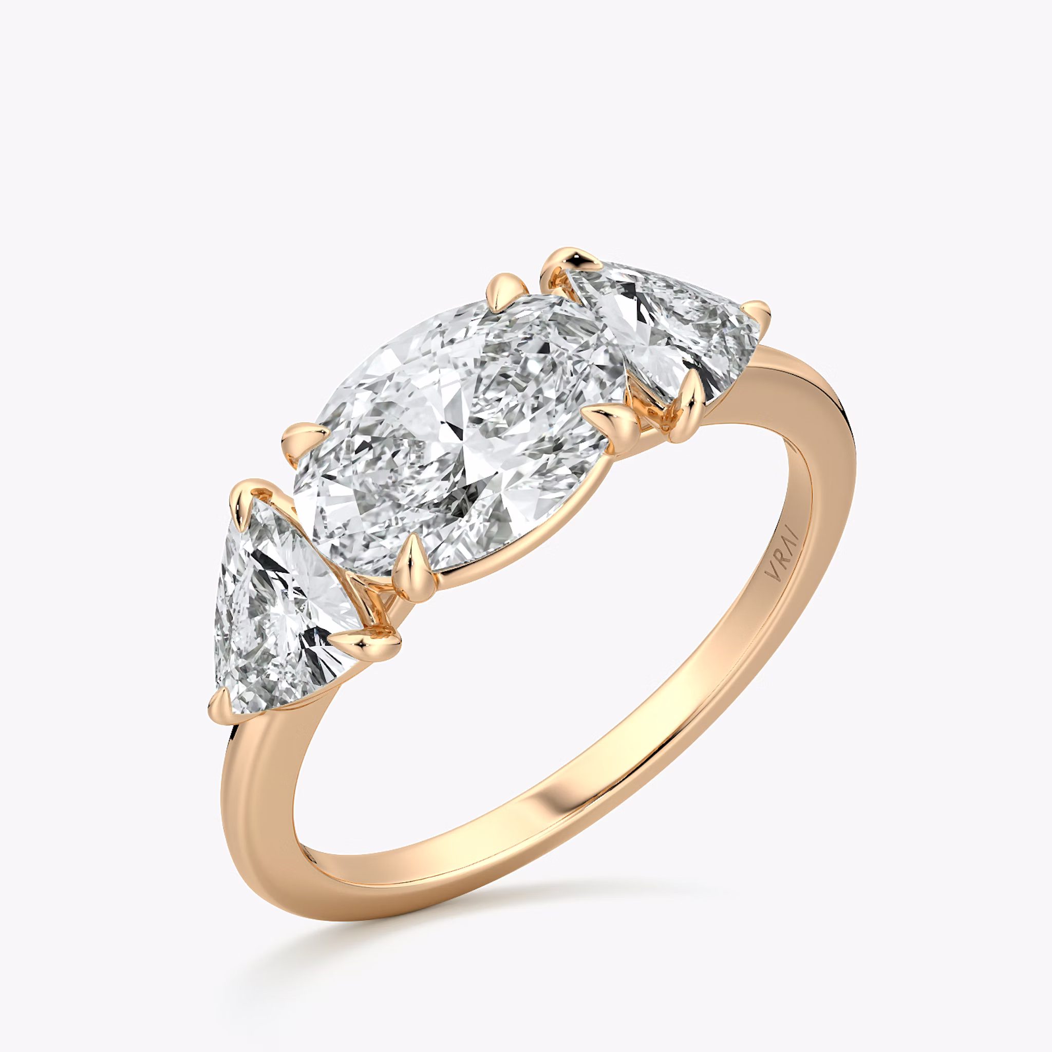 The Three Stone | Oval | 14k | Rose Gold | bandAccent: Plain | diamondOrientation: horizontal | sideStoneCarat: 0.50ct | sideStoneShape: Trillion | caratWeight: other