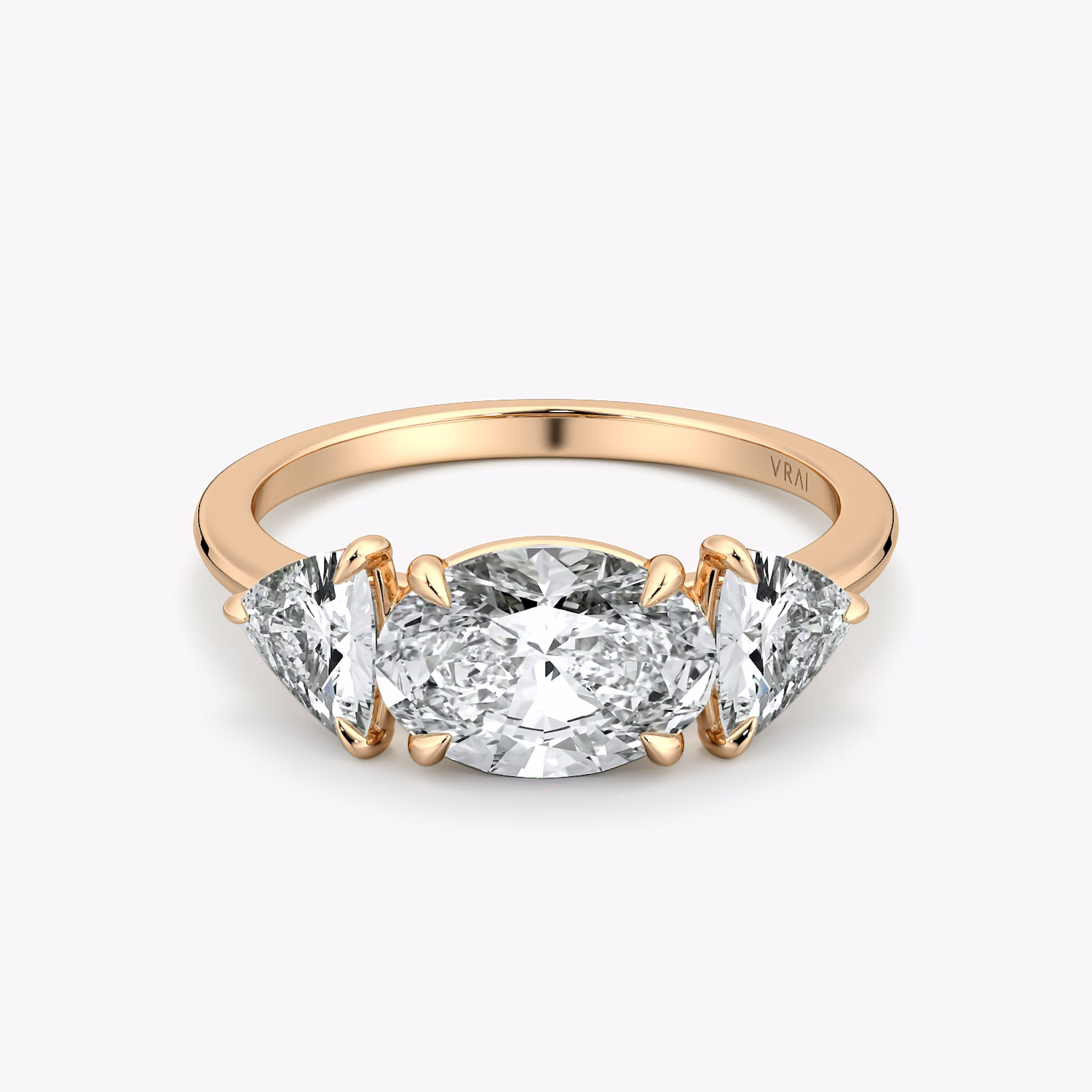 The Three Stone | Oval | 14k | Rose Gold | bandAccent: Plain | diamondOrientation: horizontal | sideStoneCarat: 0.50ct | sideStoneShape: Trillion | caratWeight: other