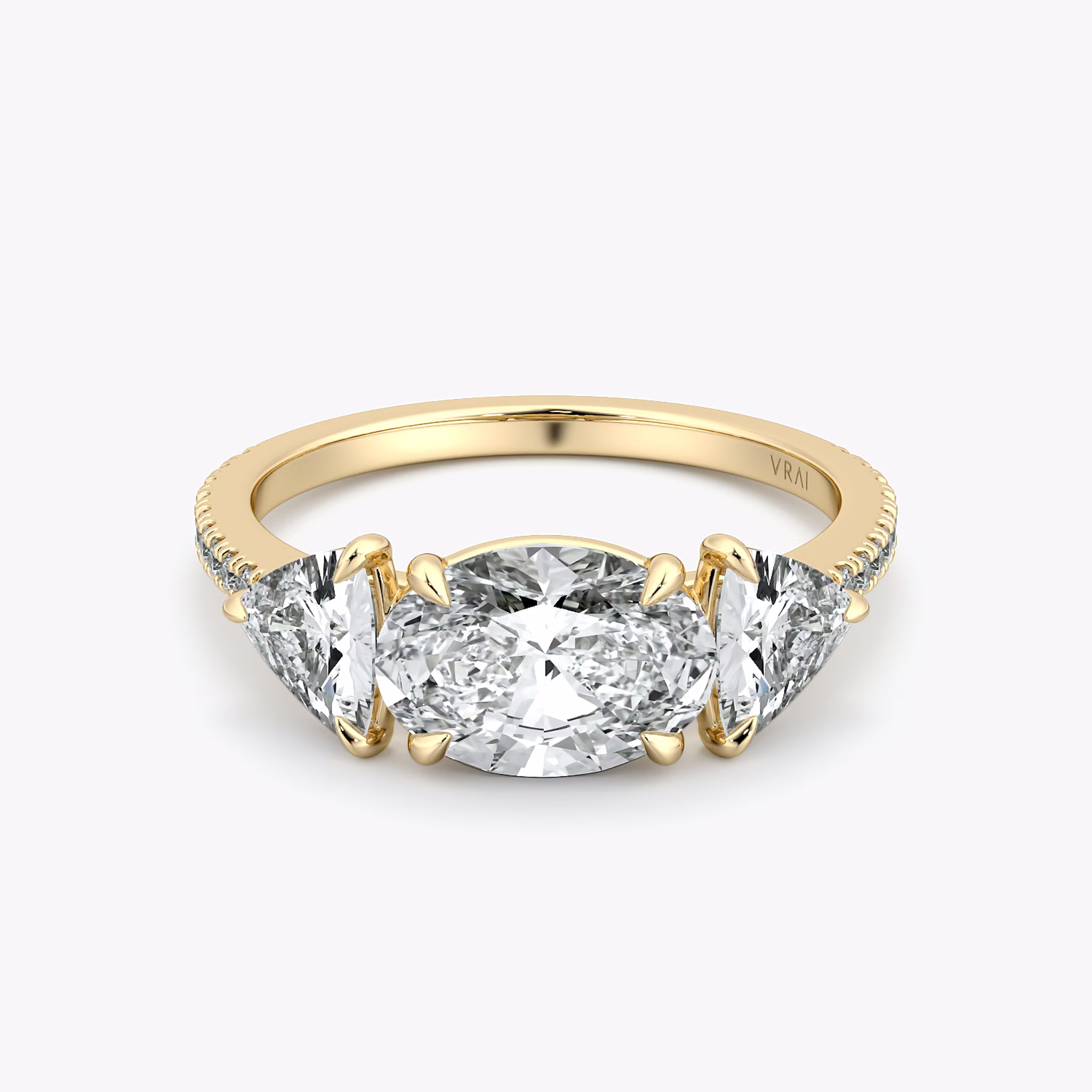 The Three Stone | Oval | 18k | Yellow Gold | bandAccent: Pavé | diamondOrientation: horizontal | sideStoneCarat: 0.50ct | sideStoneShape: Trillion | caratWeight: other