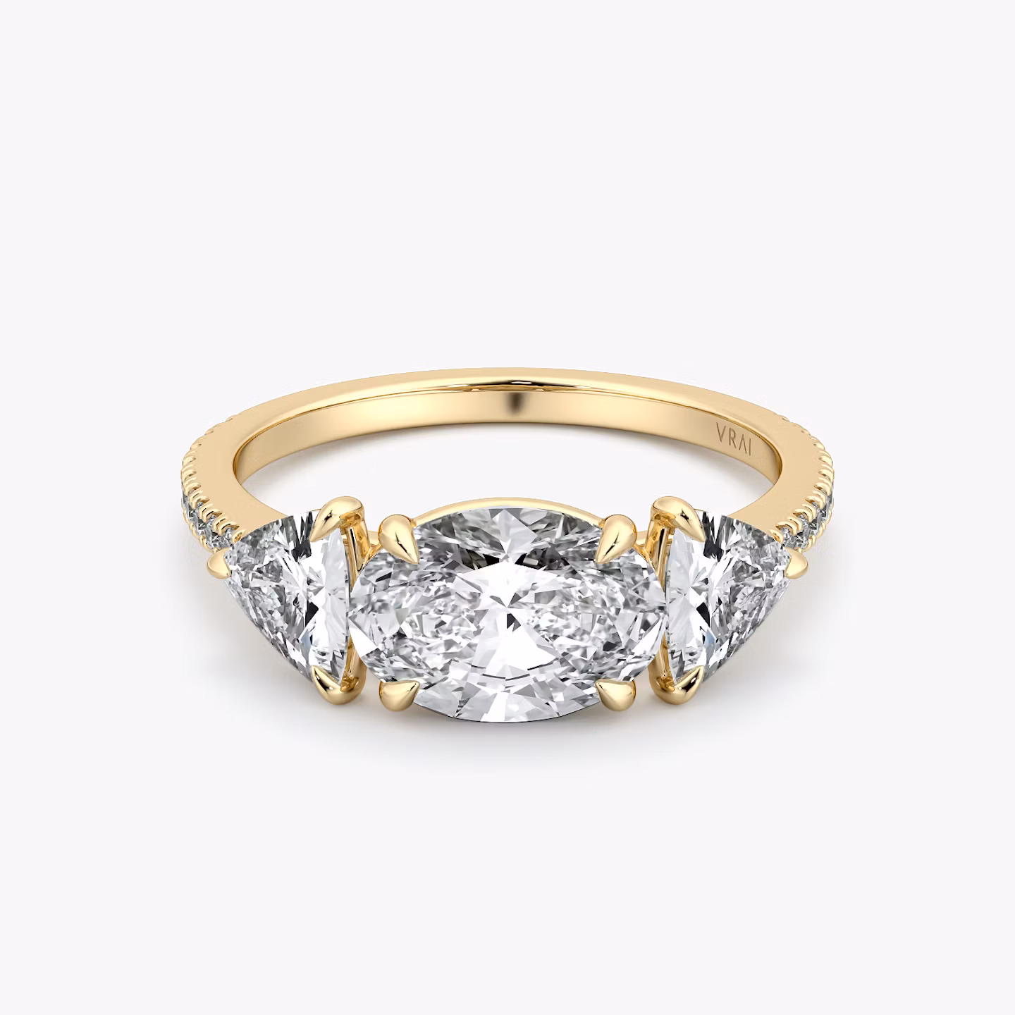 The Three Stone | Oval | 18k | Yellow Gold | bandAccent: Pavé | diamondOrientation: horizontal | sideStoneCarat: 0.50ct | sideStoneShape: Trillion | caratWeight: other