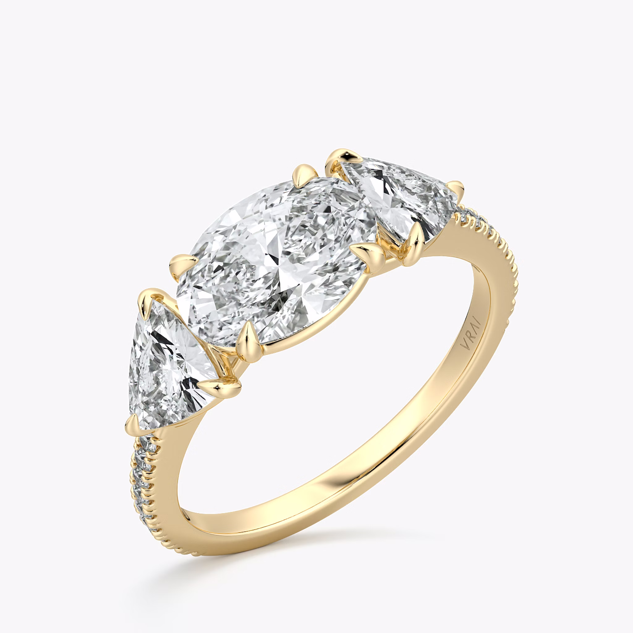 The Three Stone | Oval | 18k | Yellow Gold | bandAccent: Pavé | diamondOrientation: horizontal | sideStoneCarat: 0.50ct | sideStoneShape: Trillion | caratWeight: other