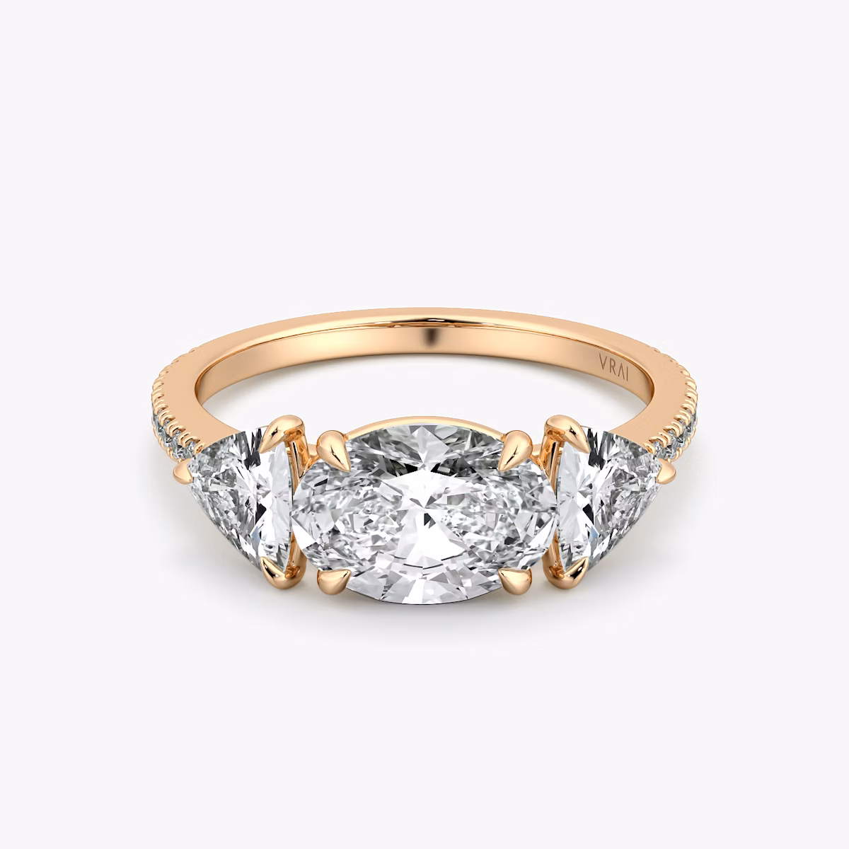 The Three Stone | Oval | 14k | Rose Gold | bandAccent: Pavé | diamondOrientation: horizontal | sideStoneCarat: 0.50ct | sideStoneShape: Trillion | caratWeight: other