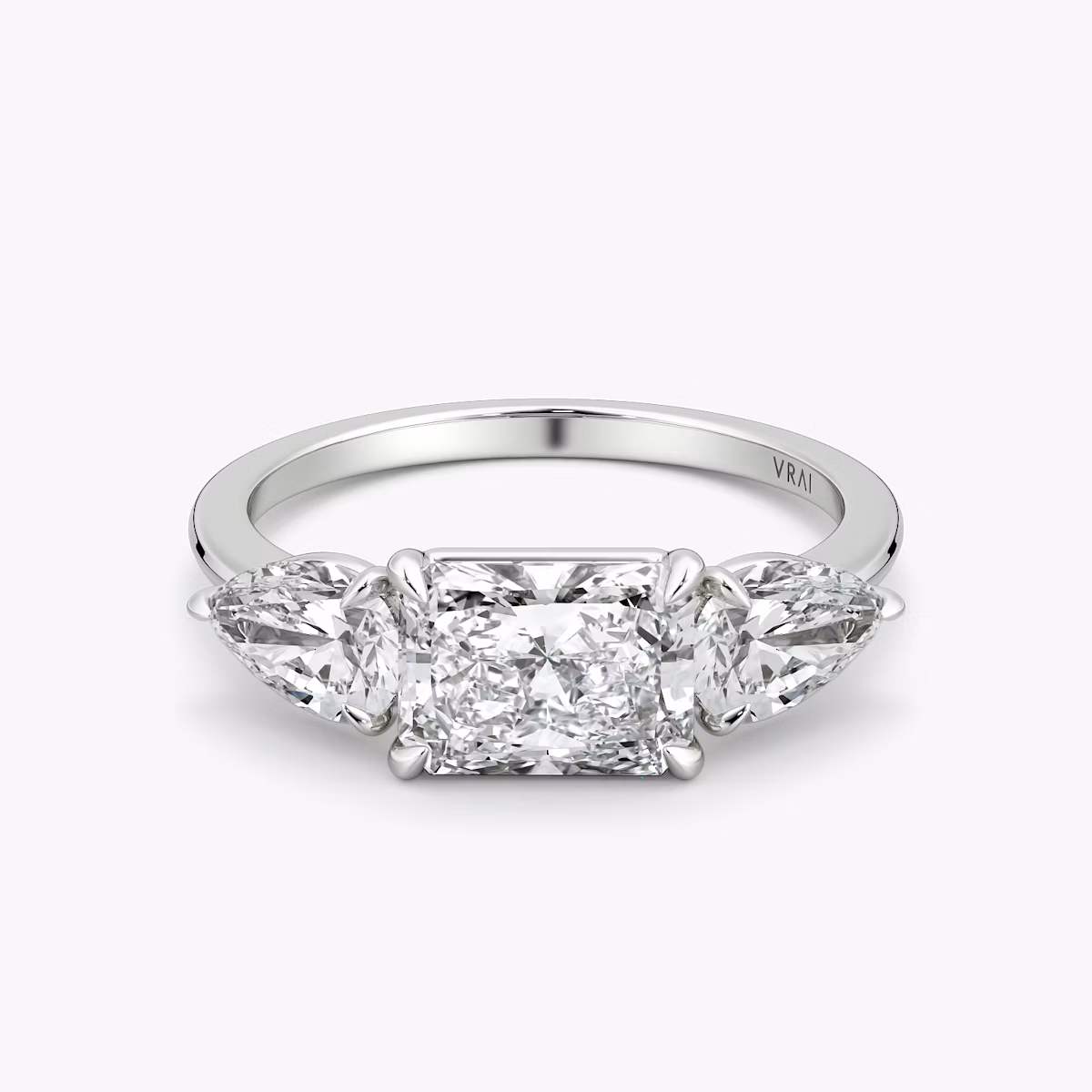 The Three Stone | Radiant | Platinum | bandAccent: Plain | diamondOrientation: horizontal | sideStoneCarat: 0.50ct | sideStoneShape: Pear | caratWeight: other