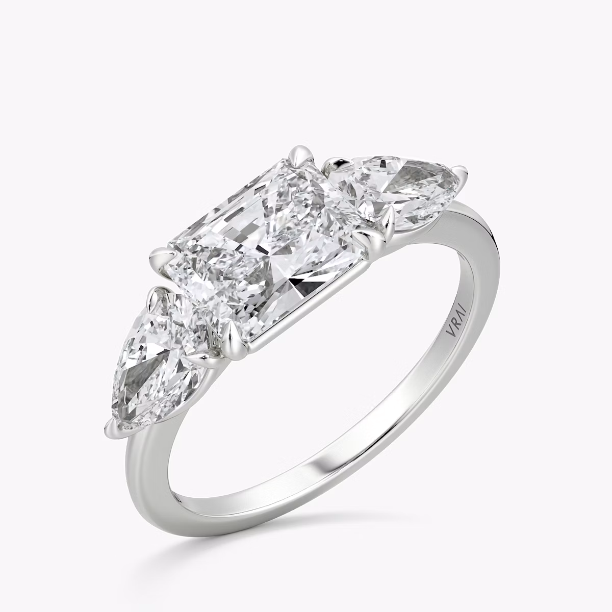 The Three Stone | Radiant | Platinum | bandAccent: Plain | diamondOrientation: horizontal | sideStoneCarat: 0.50ct | sideStoneShape: Pear | caratWeight: other