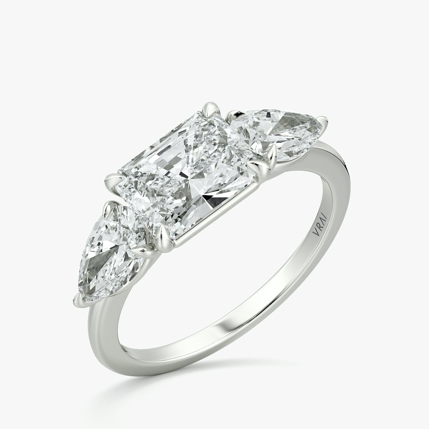 The Three Stone | Radiant | Platinum | bandAccent: Plain | diamondOrientation: horizontal | sideStoneCarat: 0.50ct | sideStoneShape: Pear | caratWeight: other