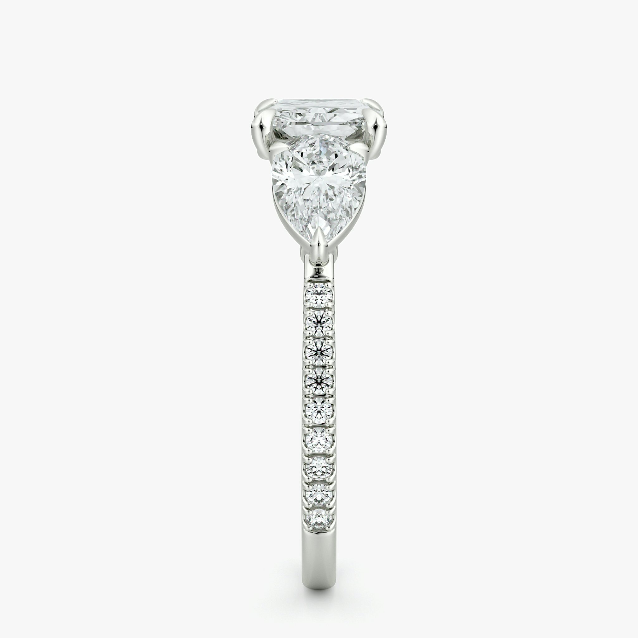 The Three Stone | Radiant | Platinum | bandAccent: Pavé | diamondOrientation: horizontal | sideStoneCarat: 0.50ct | sideStoneShape: Pear | caratWeight: other