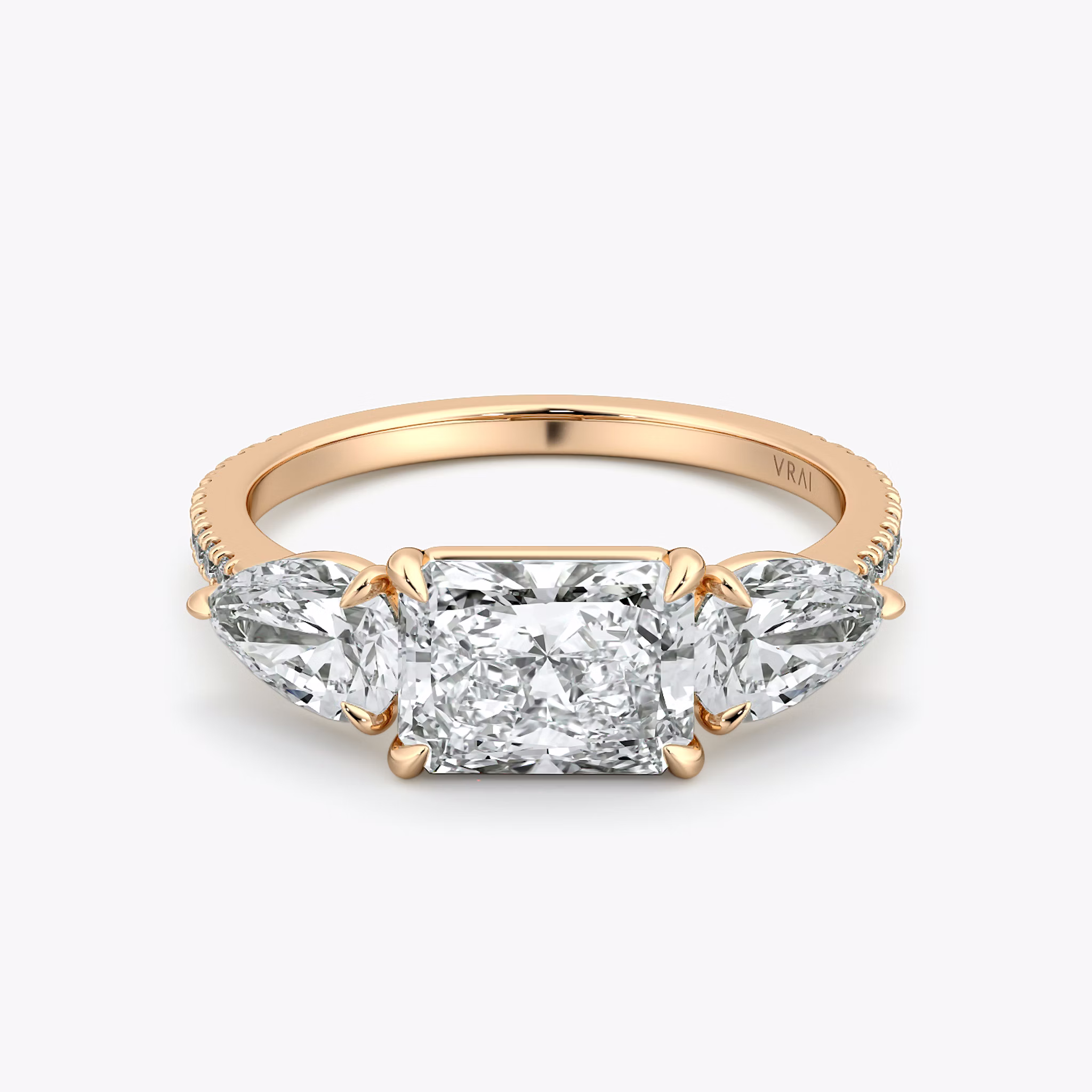 The Three Stone | Radiant | 14k | Rose Gold | bandAccent: Pavé | diamondOrientation: horizontal | sideStoneCarat: 0.50ct | sideStoneShape: Pear | caratWeight: other