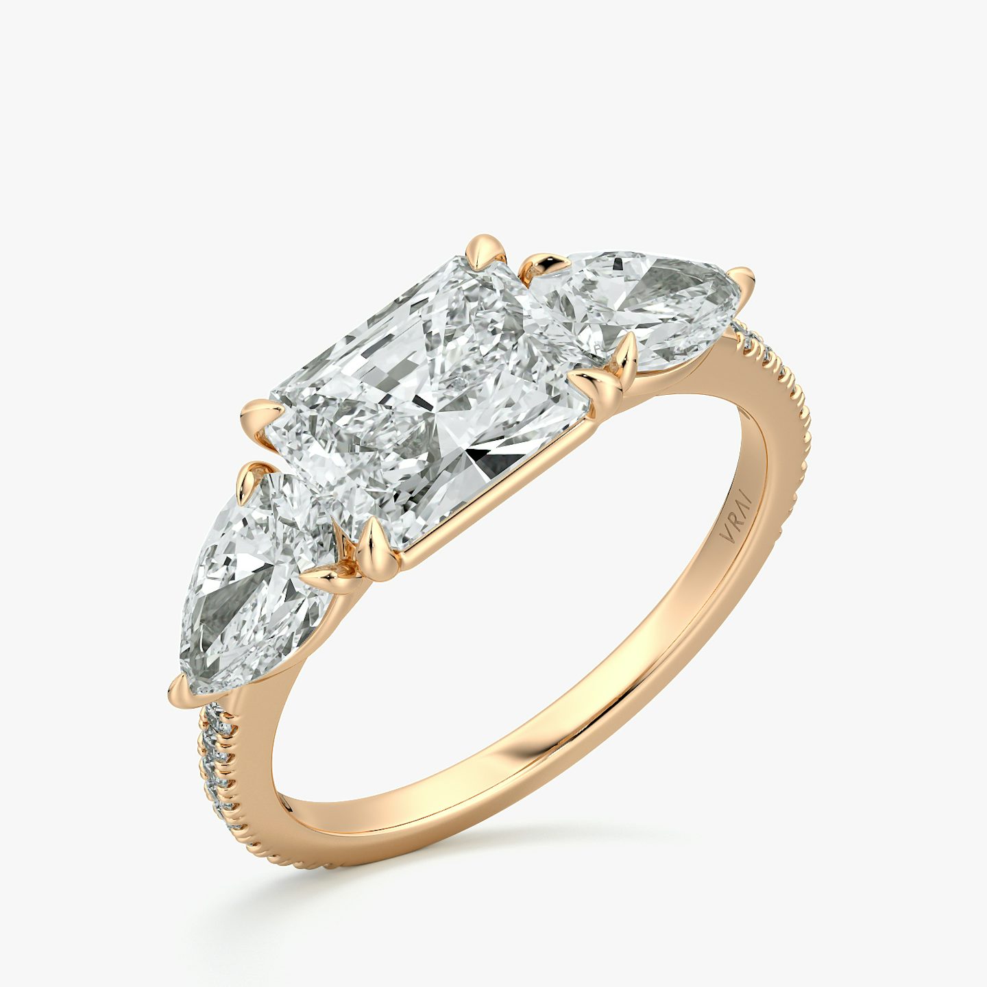The Three Stone | Radiant | 14k | Rose Gold | bandAccent: Pavé | diamondOrientation: horizontal | sideStoneCarat: 0.50ct | sideStoneShape: Pear | caratWeight: other