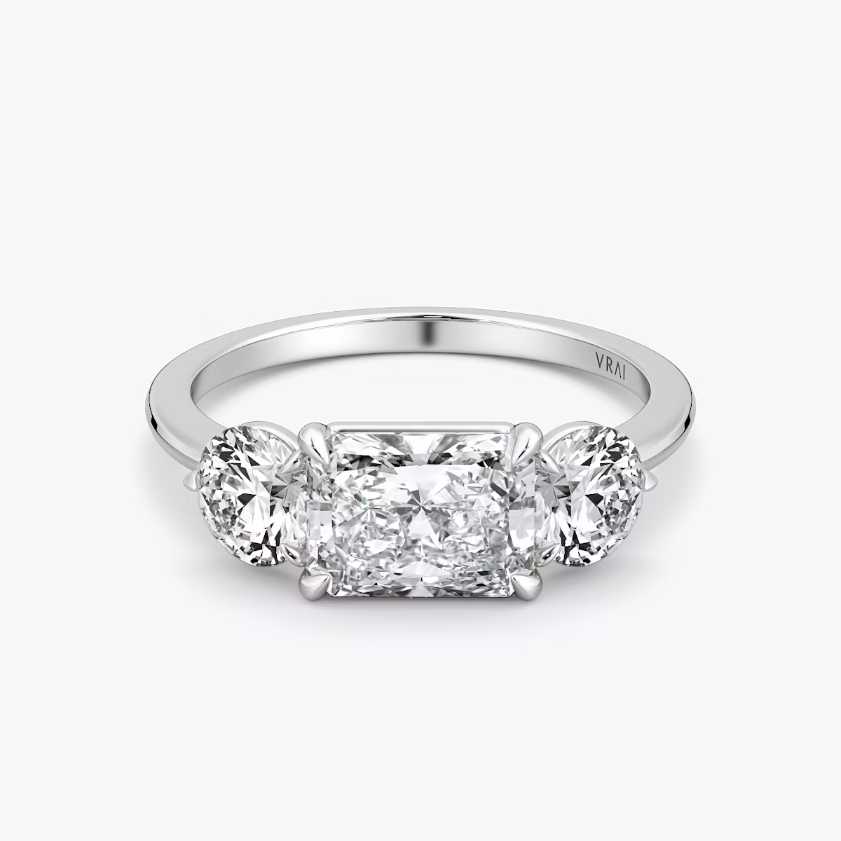 The Three Stone | Radiant | 18k | White Gold | bandAccent: Plain | diamondOrientation: horizontal | sideStoneCarat: 0.50ct | sideStoneShape: Round Brilliant | caratWeight: other