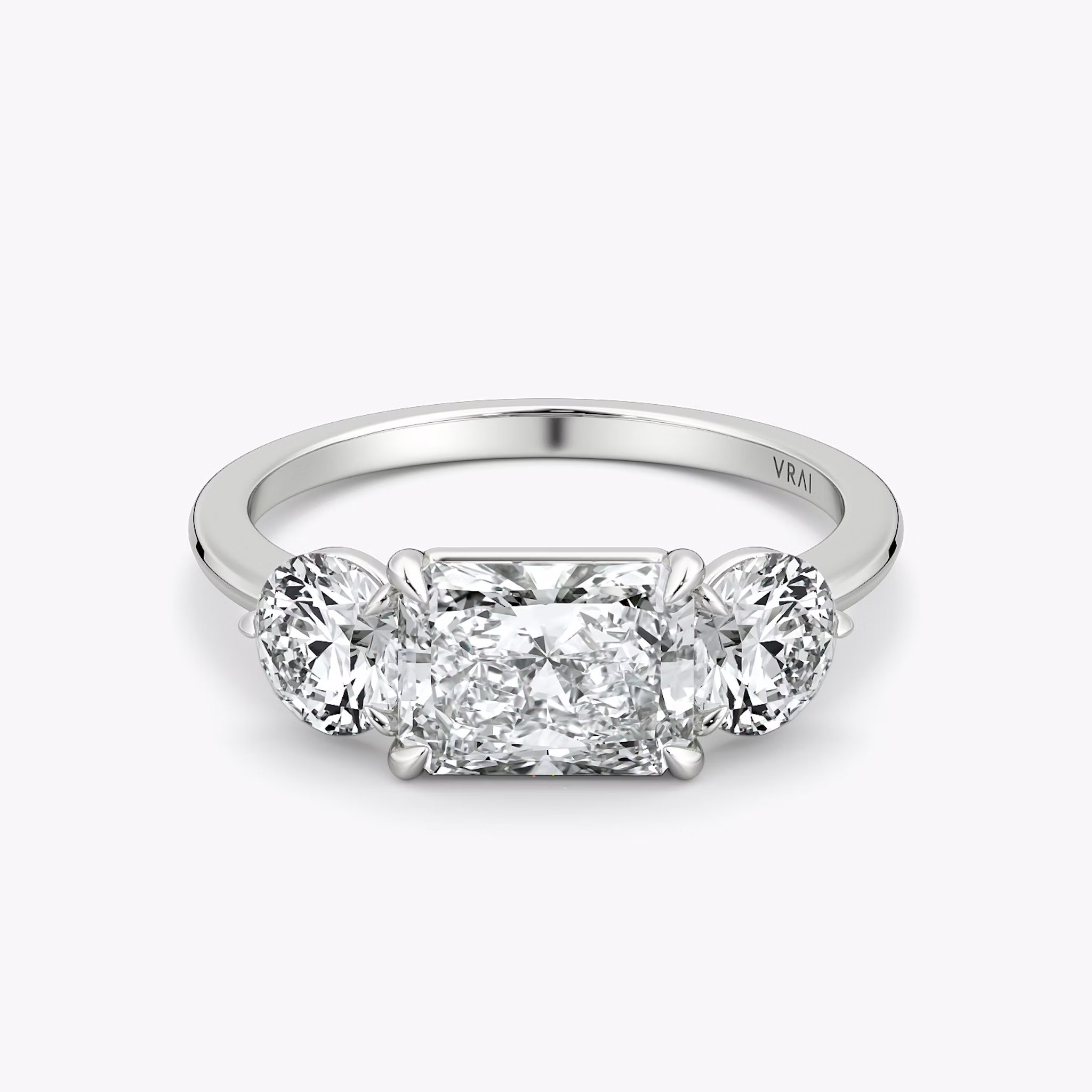 The Three Stone | Radiant | 18k | White Gold | bandAccent: Plain | diamondOrientation: horizontal | sideStoneCarat: 0.50ct | sideStoneShape: Round Brilliant | caratWeight: other