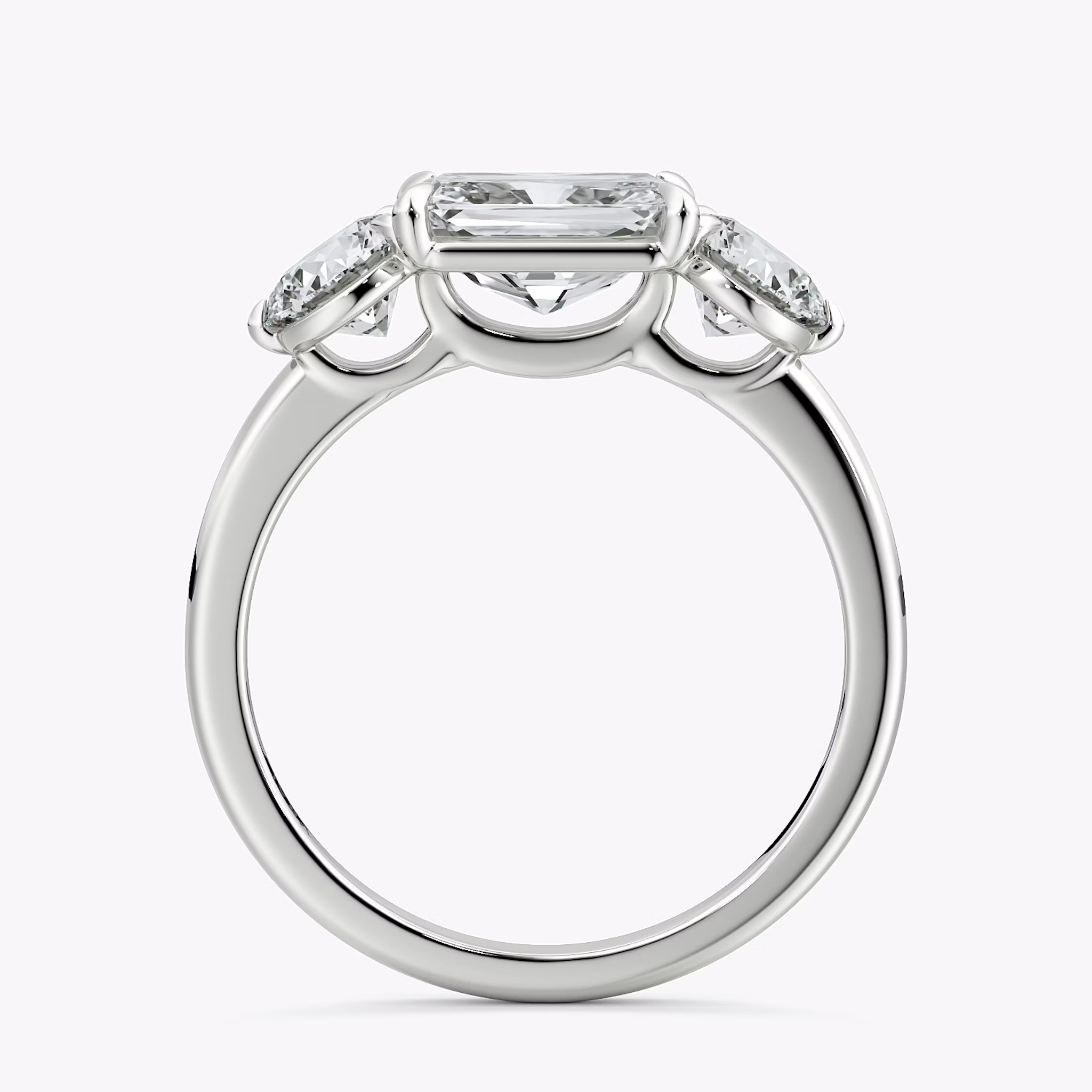 The Three Stone | Radiant | 18k | White Gold | bandAccent: Plain | diamondOrientation: horizontal | sideStoneCarat: 0.50ct | sideStoneShape: Round Brilliant | caratWeight: other