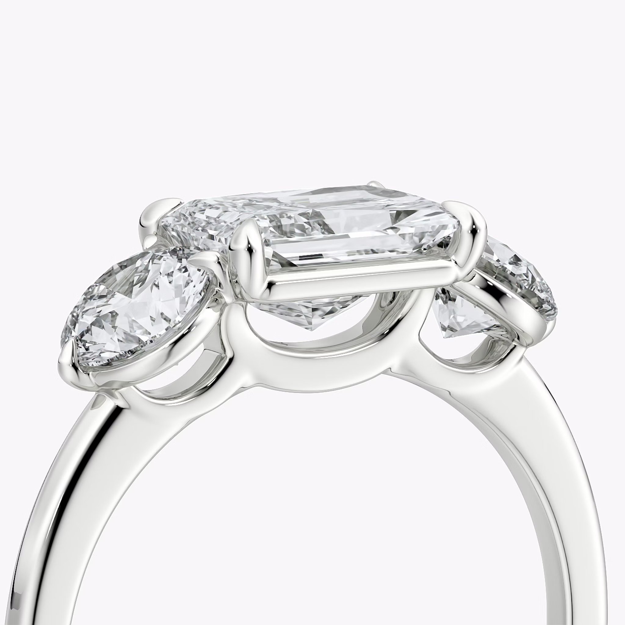The Three Stone | Radiant | 18k | White Gold | bandAccent: Plain | diamondOrientation: horizontal | sideStoneCarat: 0.50ct | sideStoneShape: Round Brilliant | caratWeight: other