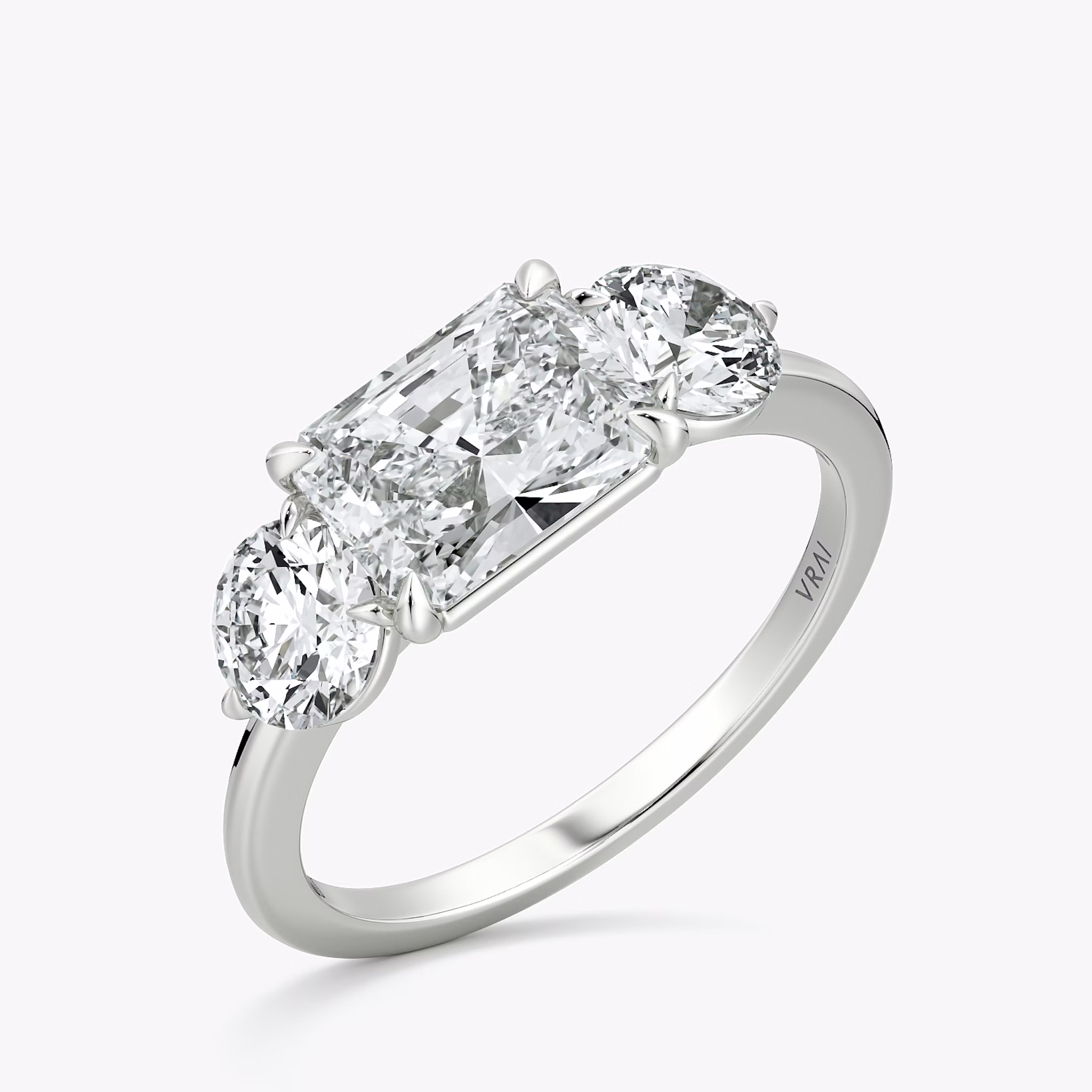The Three Stone | Radiant | 18k | White Gold | bandAccent: Plain | diamondOrientation: horizontal | sideStoneCarat: 0.50ct | sideStoneShape: Round Brilliant | caratWeight: other
