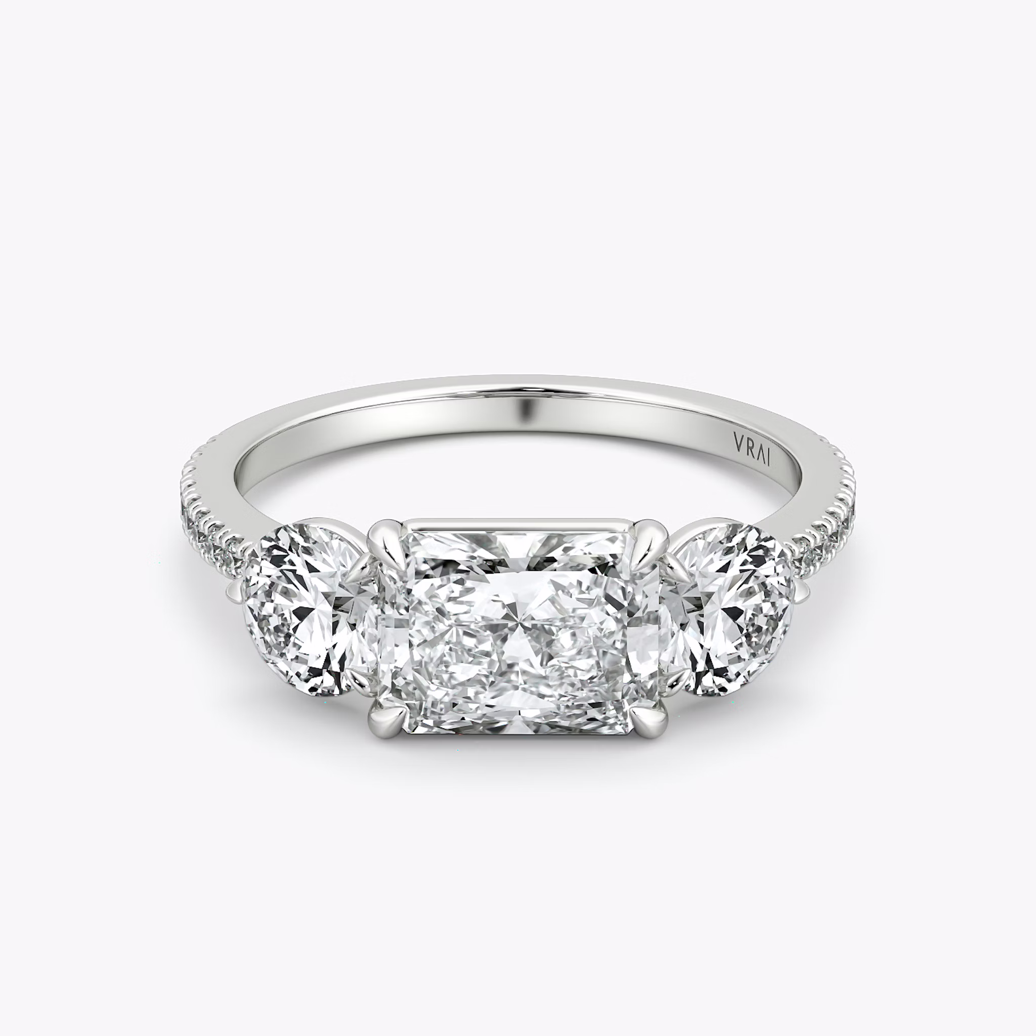The Three Stone | Radiant | 18k | White Gold | bandAccent: Pavé | diamondOrientation: horizontal | sideStoneCarat: 0.50ct | sideStoneShape: Round Brilliant | caratWeight: other