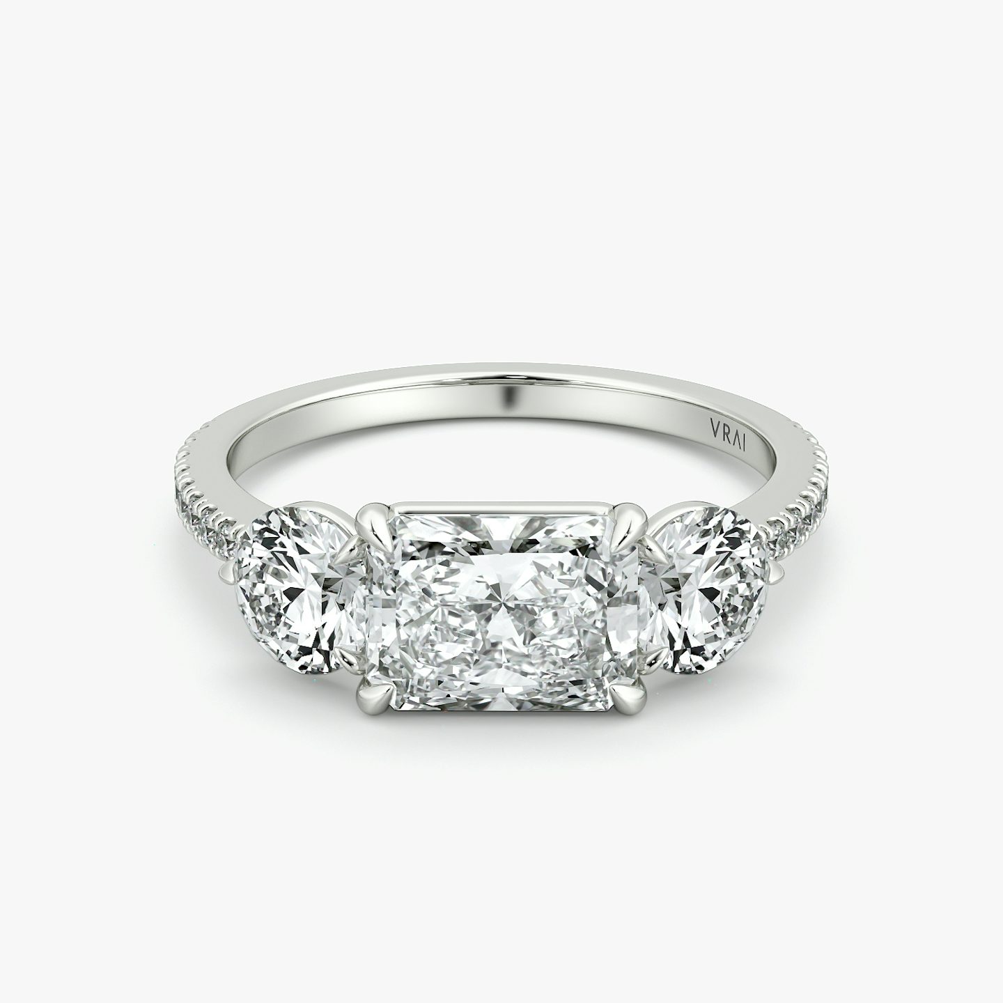 The Three Stone | Radiant | 18k | White Gold | bandAccent: Pavé | diamondOrientation: horizontal | sideStoneCarat: 0.50ct | sideStoneShape: Round Brilliant | caratWeight: other