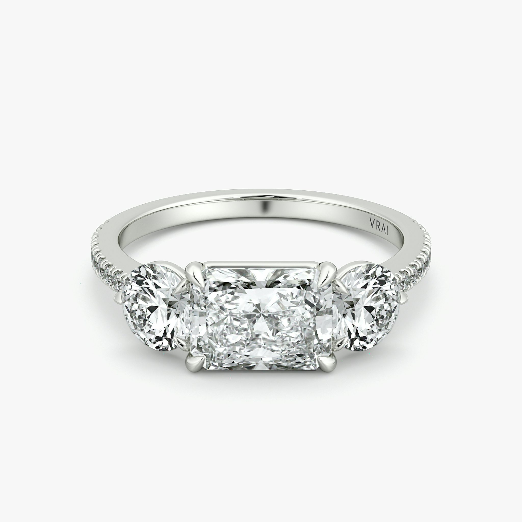 The Three Stone | Radiant | 18k | White Gold | bandAccent: Pavé | diamondOrientation: horizontal | sideStoneCarat: 0.50ct | sideStoneShape: Round Brilliant | caratWeight: other