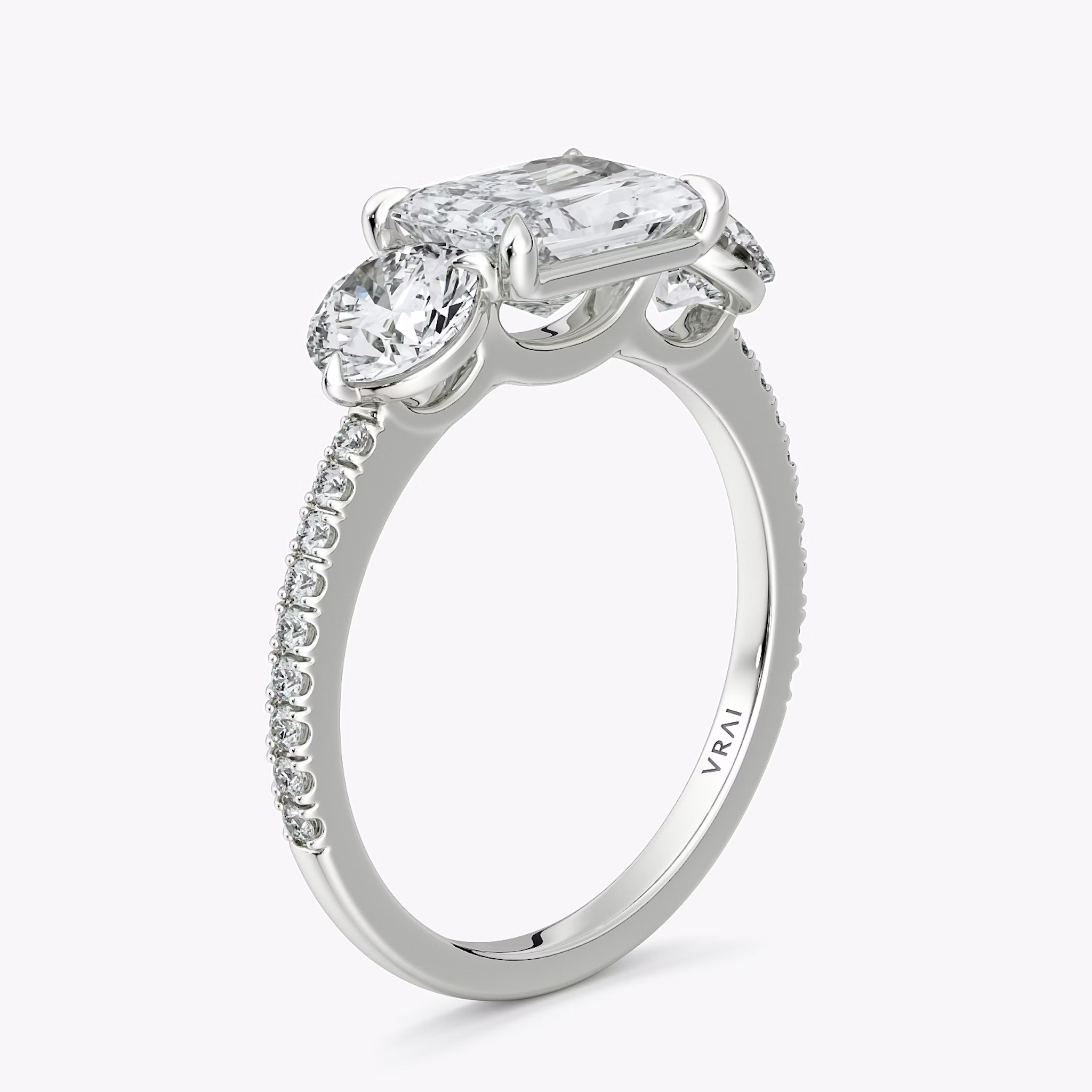 The Three Stone | Radiant | 18k | White Gold | bandAccent: Pavé | diamondOrientation: horizontal | sideStoneCarat: 0.50ct | sideStoneShape: Round Brilliant | caratWeight: other