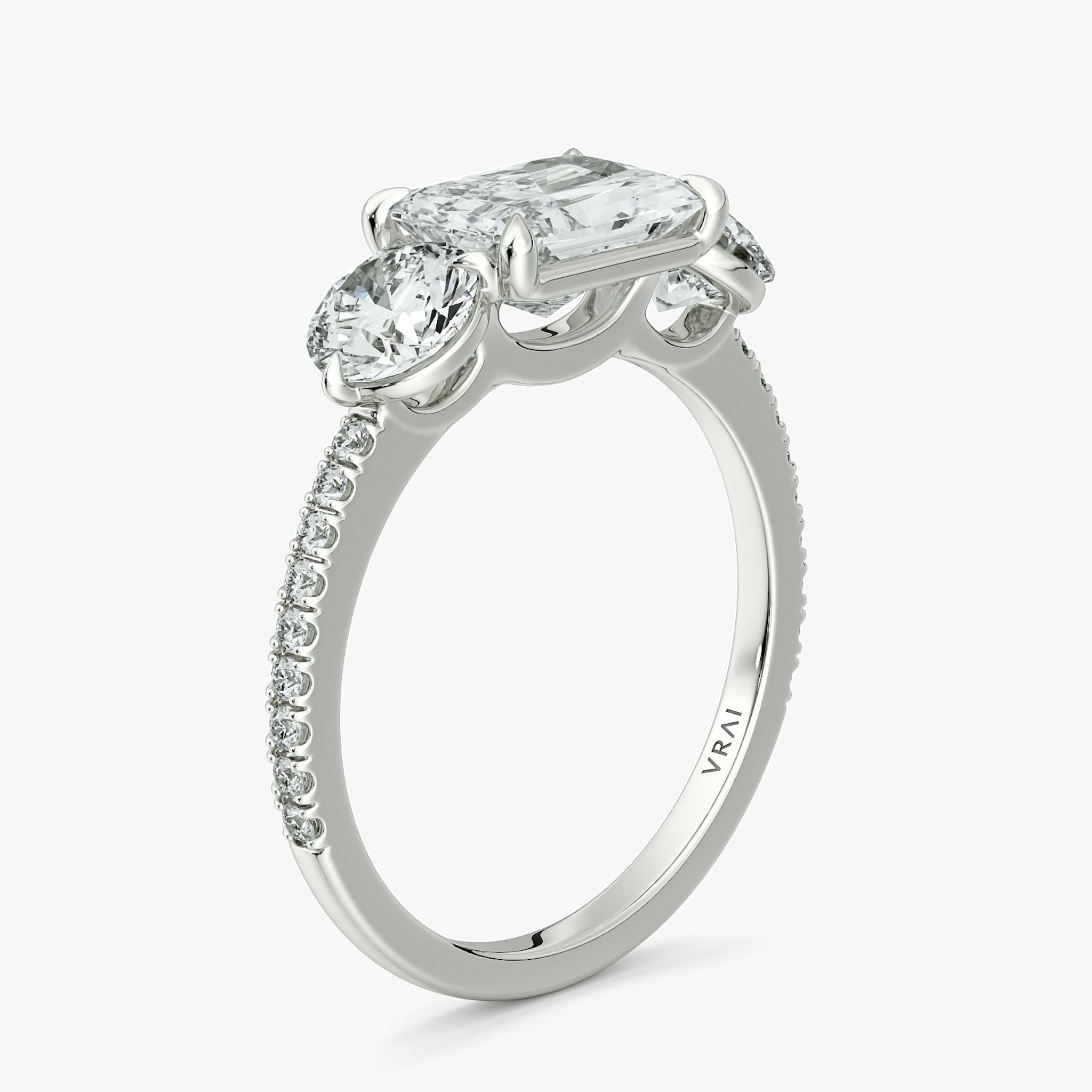 The Three Stone | Radiant | 18k | White Gold | bandAccent: Pavé | diamondOrientation: horizontal | sideStoneCarat: 0.50ct | sideStoneShape: Round Brilliant | caratWeight: other