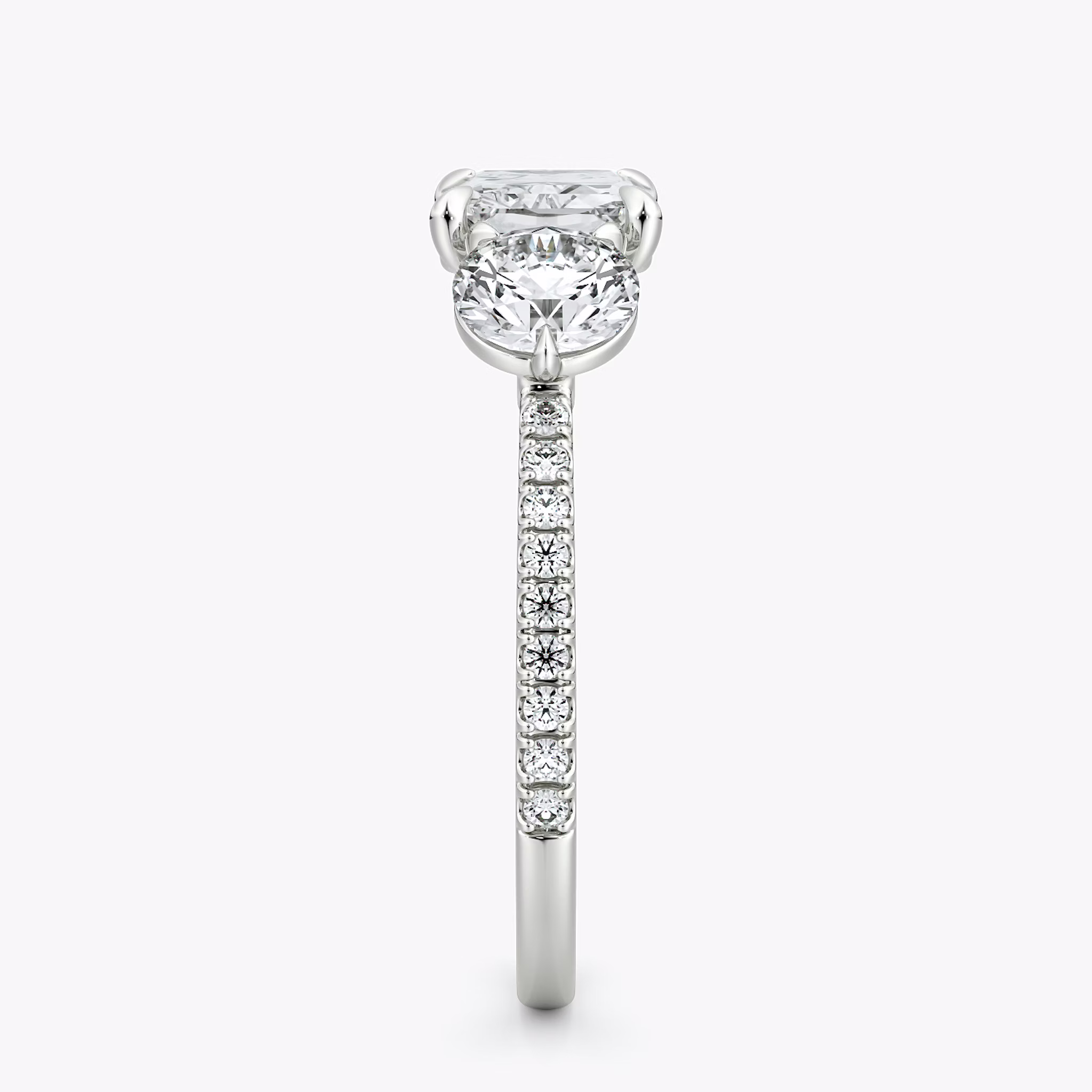 The Three Stone | Radiant | 18k | White Gold | bandAccent: Pavé | diamondOrientation: horizontal | sideStoneCarat: 0.50ct | sideStoneShape: Round Brilliant | caratWeight: other
