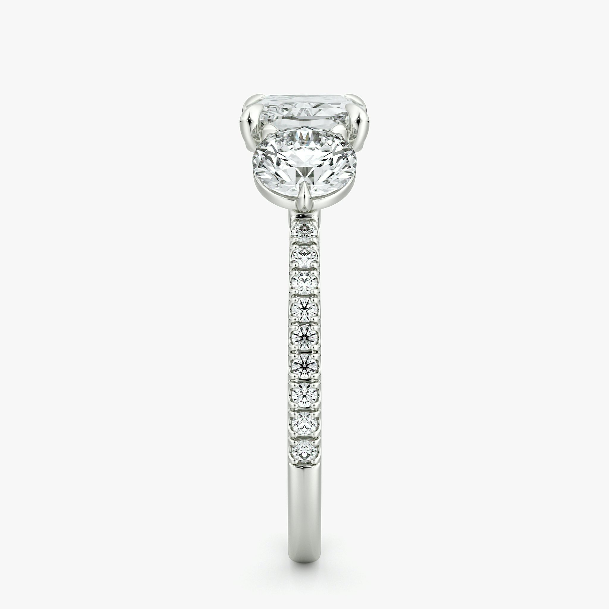 The Three Stone | Radiant | 18k | White Gold | bandAccent: Pavé | diamondOrientation: horizontal | sideStoneCarat: 0.50ct | sideStoneShape: Round Brilliant | caratWeight: other