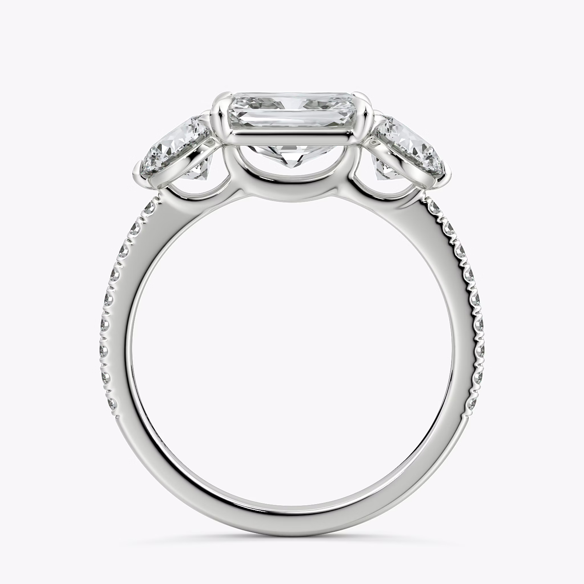 The Three Stone | Radiant | 18k | White Gold | bandAccent: Pavé | diamondOrientation: horizontal | sideStoneCarat: 0.50ct | sideStoneShape: Round Brilliant | caratWeight: other